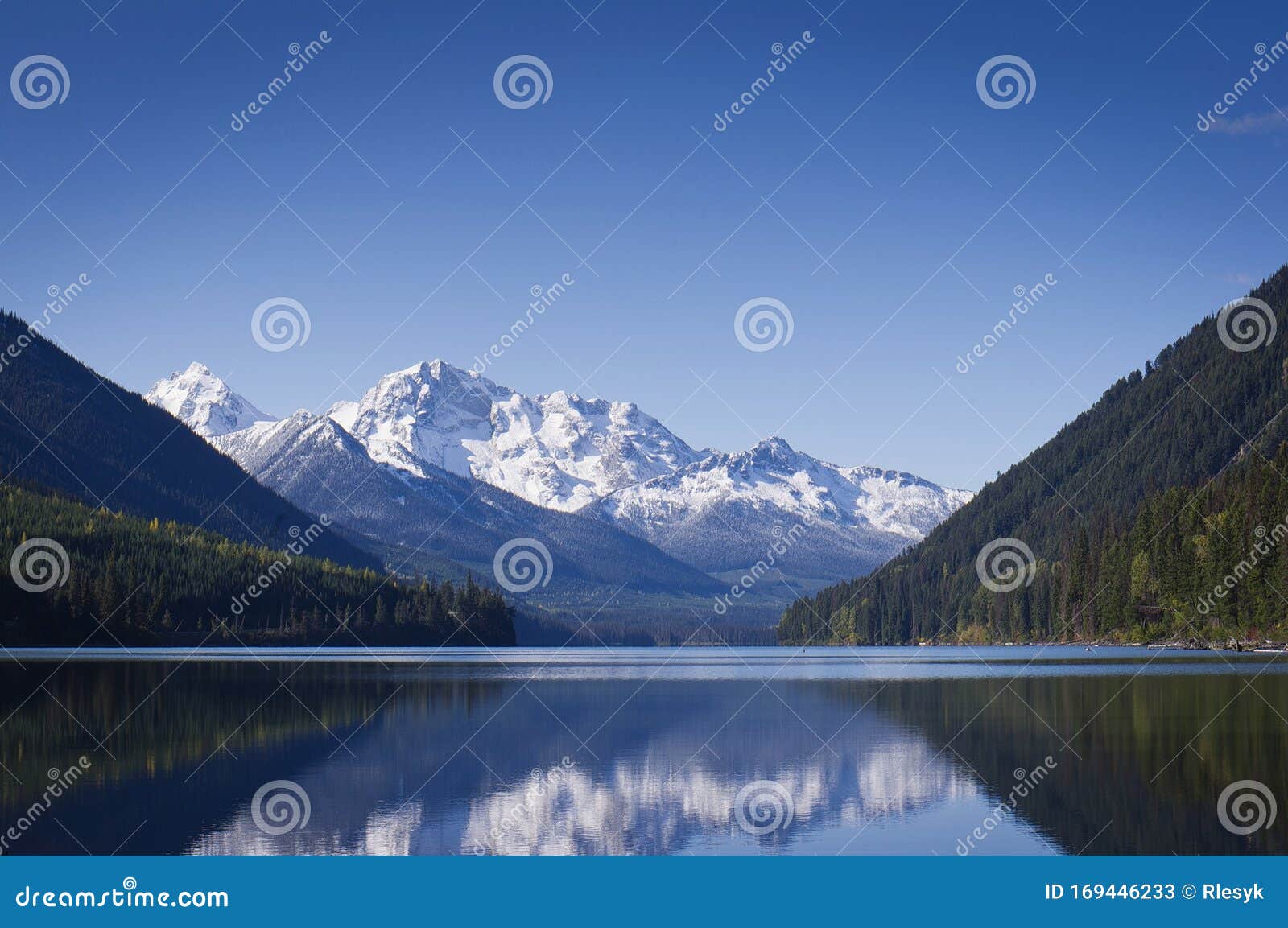 calm duffy lake and snow covered mountains