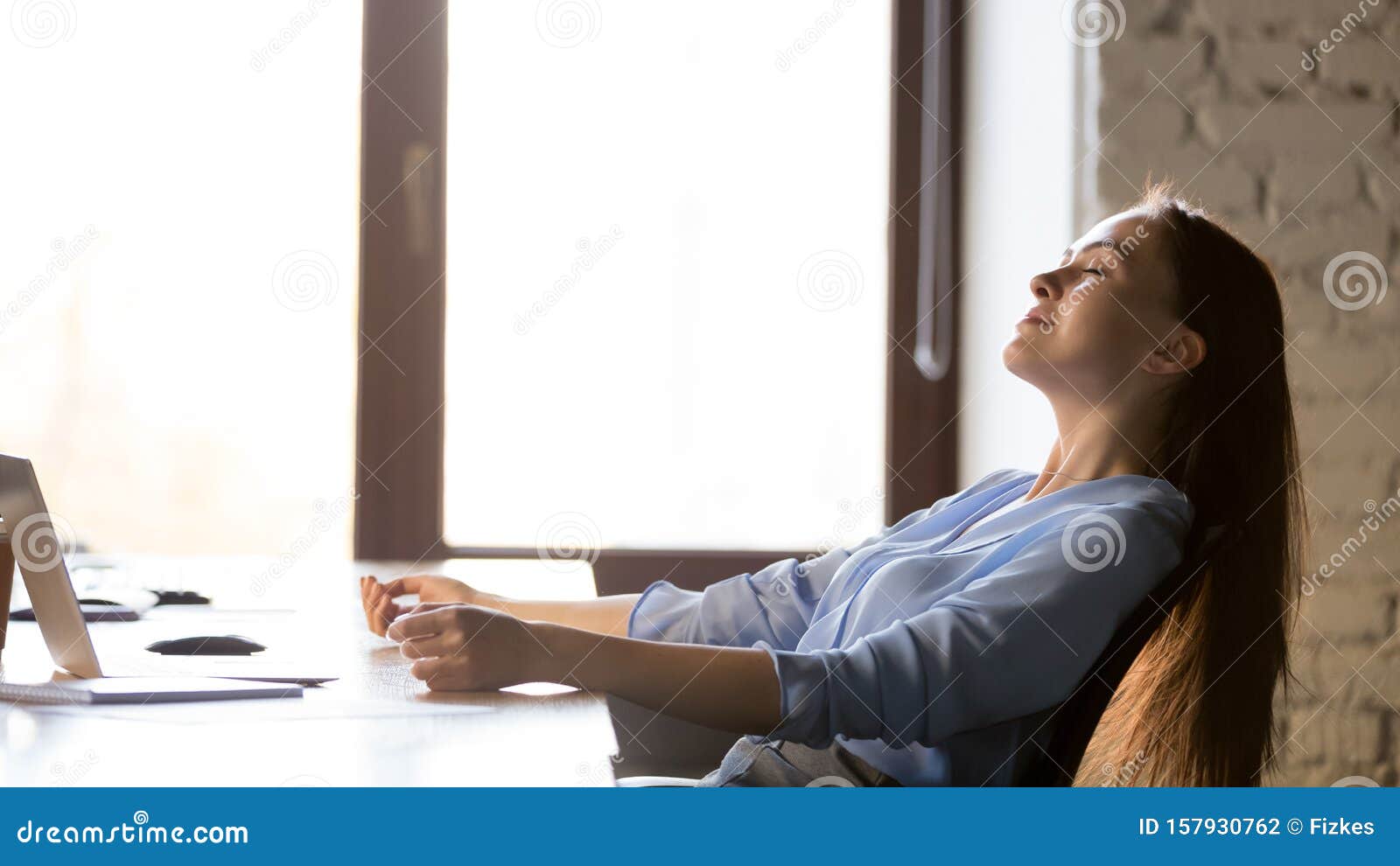 calm businesswoman relaxing in comfortable office chair at work