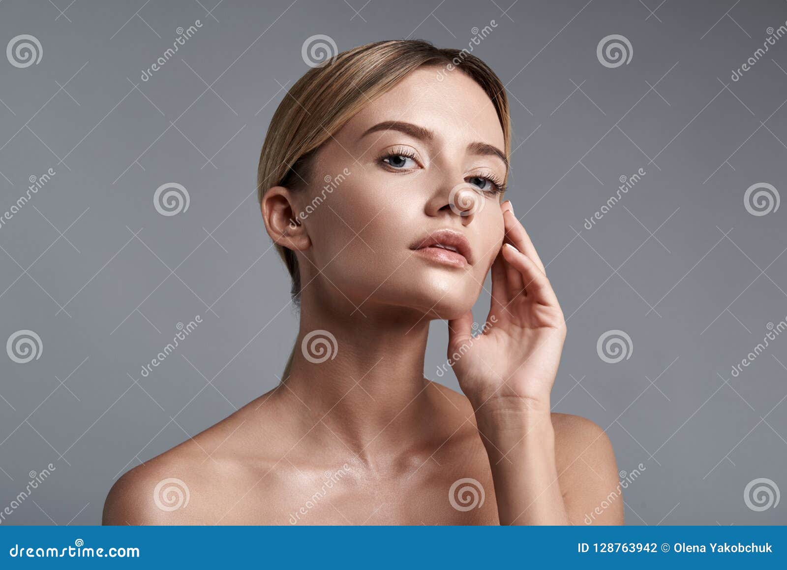 Thoughtful Fair Haired Lady Looking At You And Touching Her Face Stock 