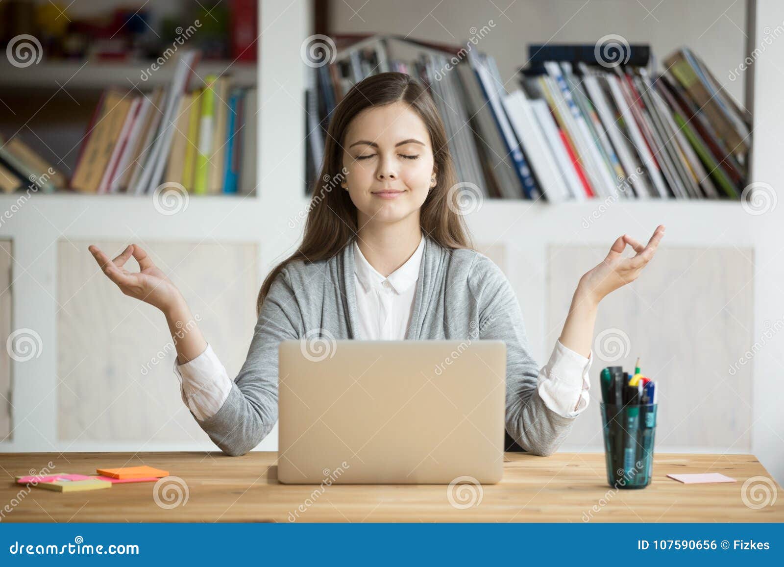 calm relaxed woman meditating with laptop, no stress at work