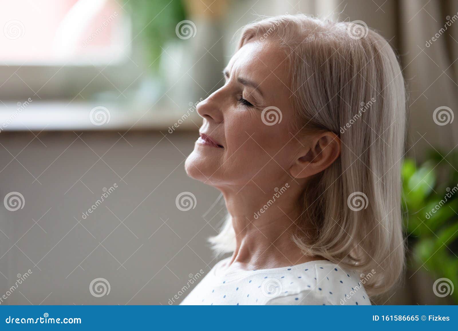 calm serene middle aged woman breathing with eyes closed