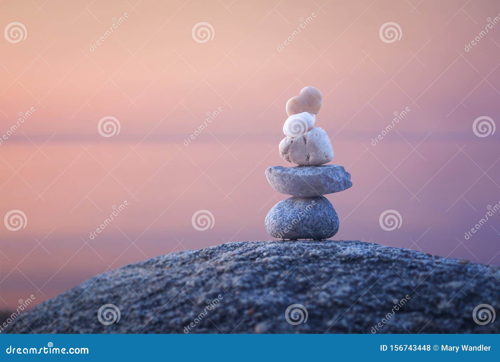 calming zen rock stack by a lake