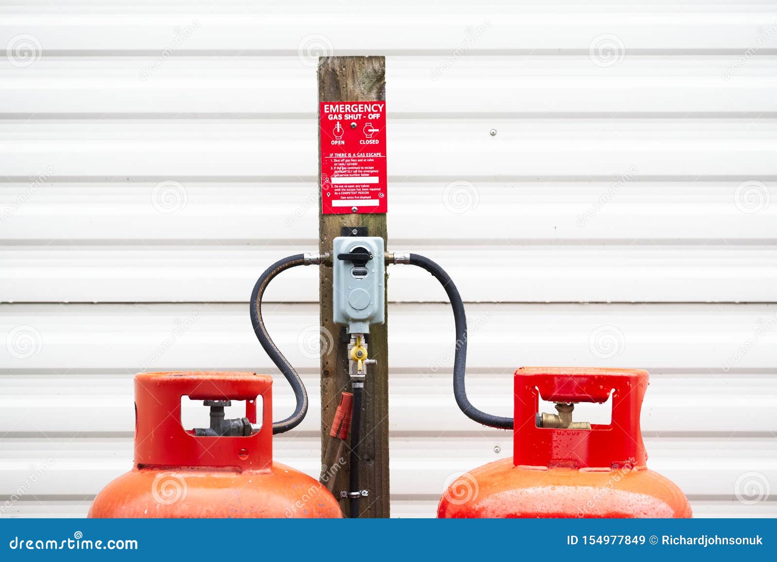 calor gas cylinder bottles refilling with hose at refill point within caravan park site