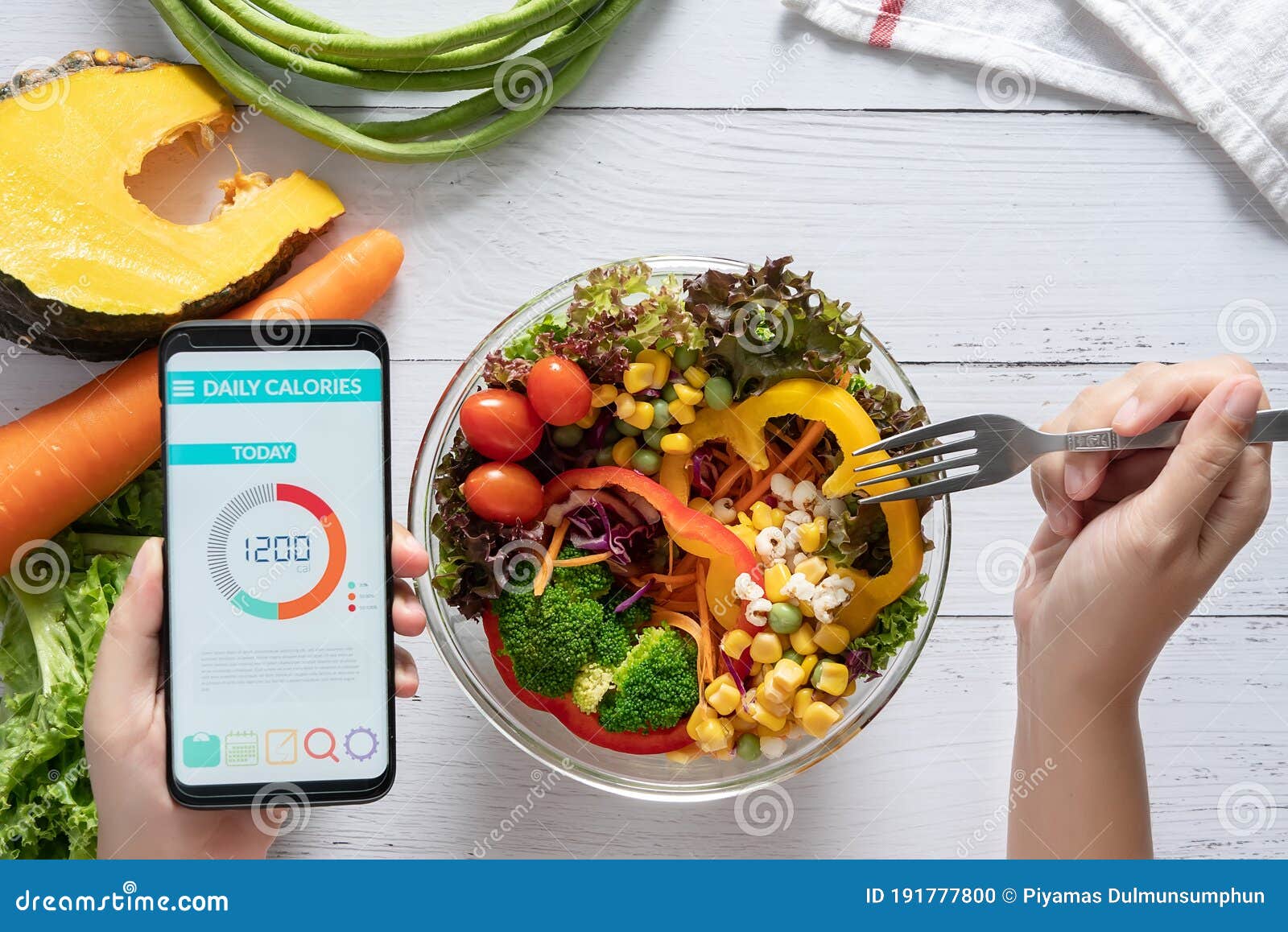 calories counting , diet , food control and weight loss concept. calorie counter application on smartphone screen at dining table