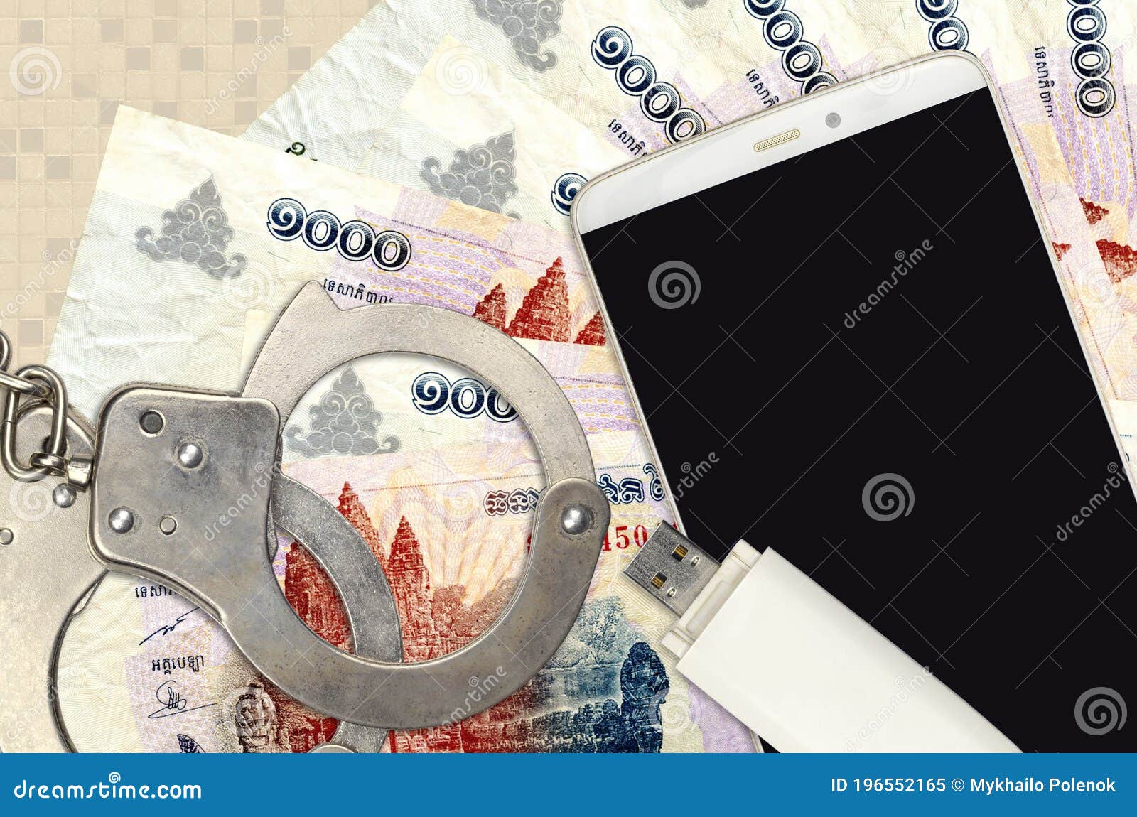 1000 cambodian riels bills and smartphone with police handcuffs. concept of hackers phishing attacks, illegal scam or malware soft