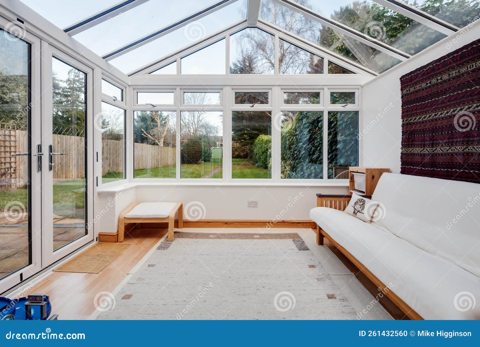 UPVC white conservatory. Cambridge, England - Jan 15 2019: UPVC white garden room conservatory furnished with white sofa and laminate floor