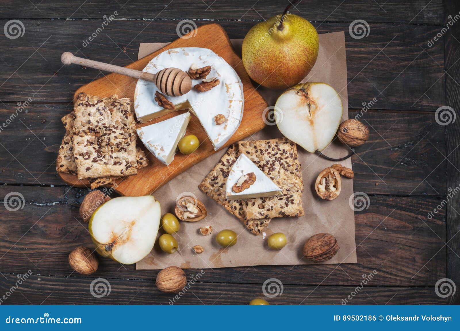 Camembert Cheese with Walnuts, Honey and Pears on Rustic Table Stock