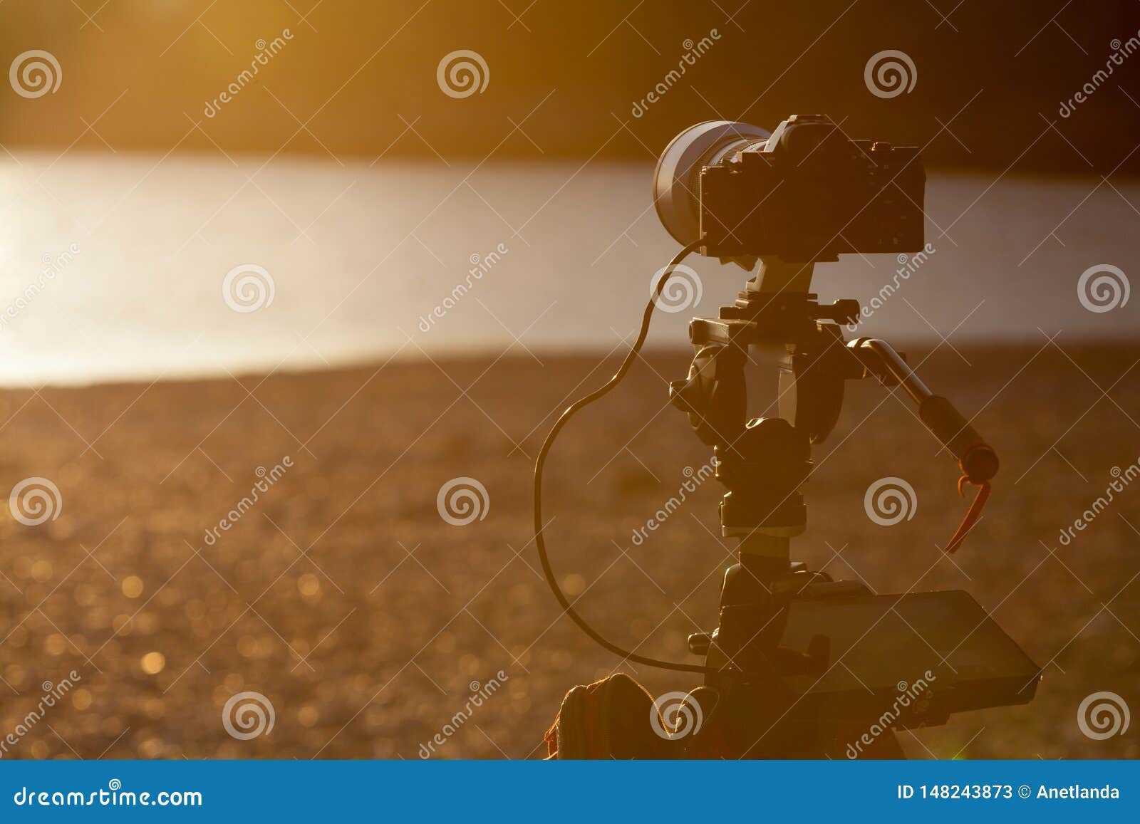 Camera DSLR Set on Tripod Capturing Sunset on Beach Stock Image Image