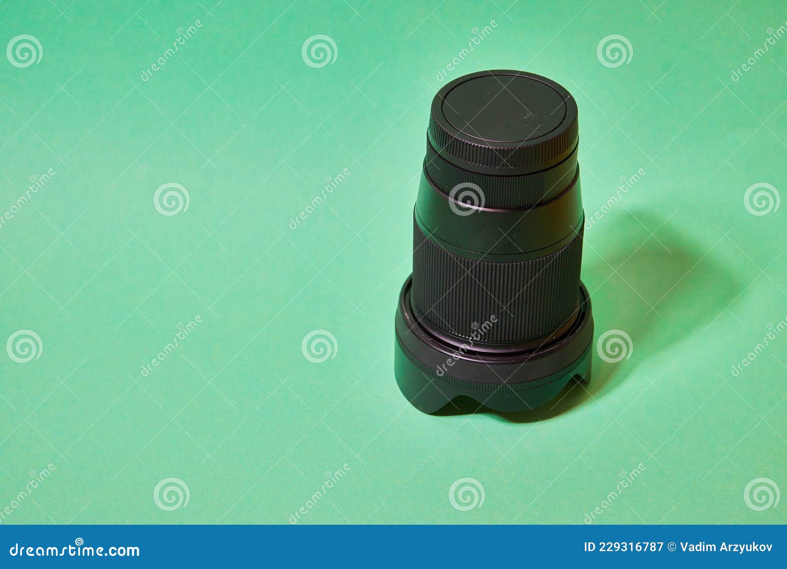 camera lens with protective cover on a green background