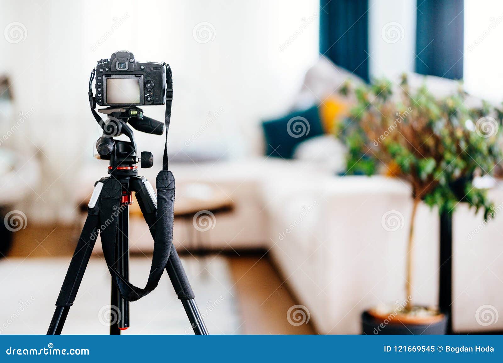 camera on tripod taking photographs of interior , furniture and houses