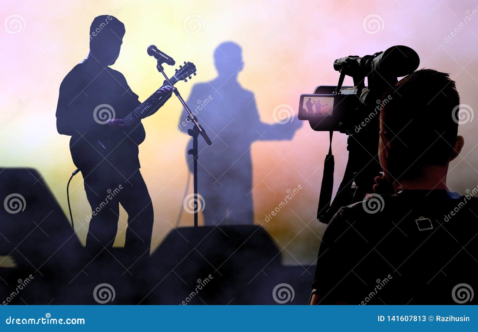 cameraman recording and broadcasting live on concerts using video camera