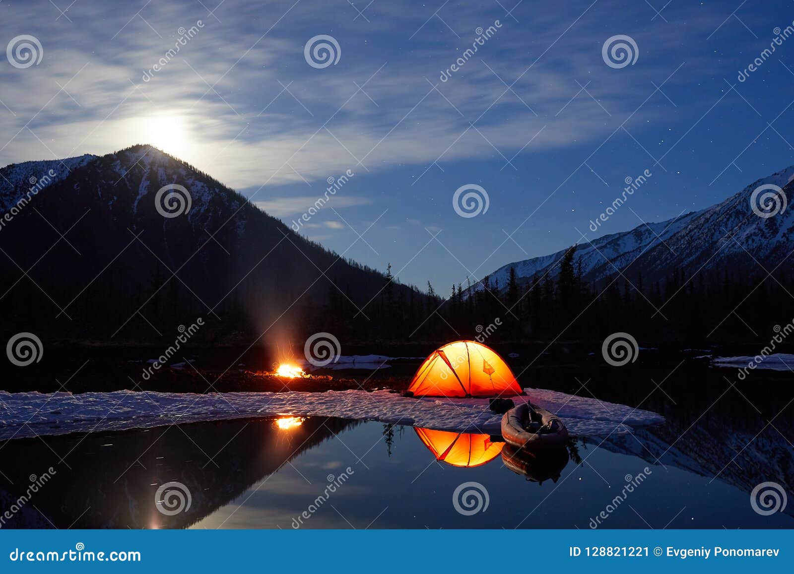 camp near the mountain lake. night landscape with a tent near the water.