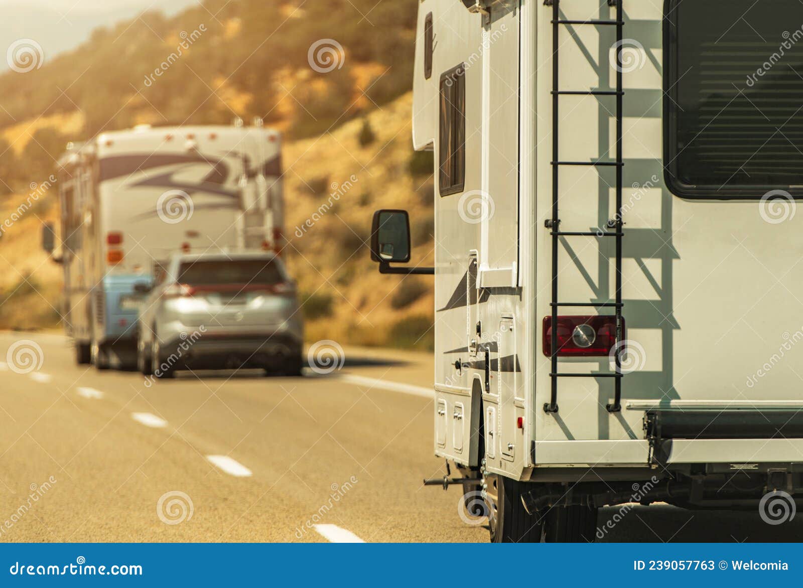 camper van and diesel pusher motorhome on a highway