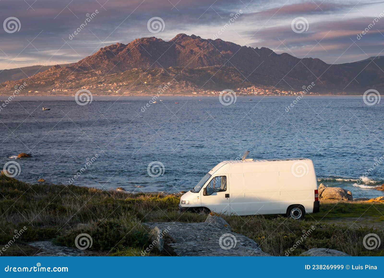 camper van motorhome with solar panels view on a sea landscape with mountains living van life in galiza, spain