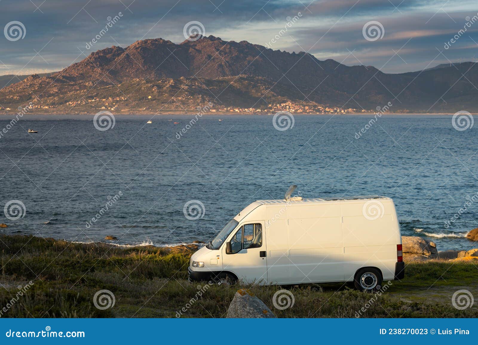 camper van motorhome with solar panels view on a sea landscape with mountains living van life in galiza, spain