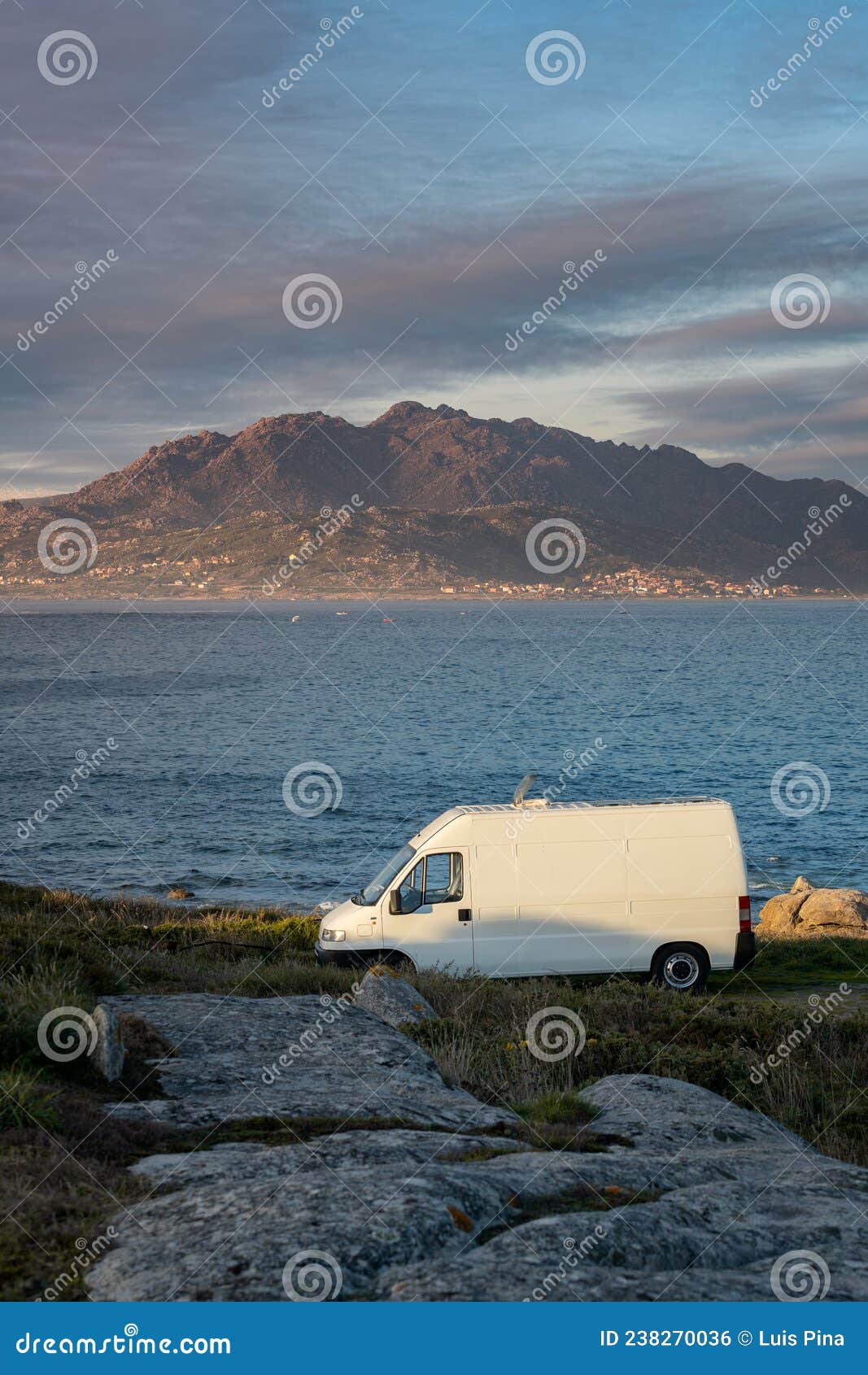 camper van motorhome with solar panels view on a sea landscape with mountains living van life in galiza, spain