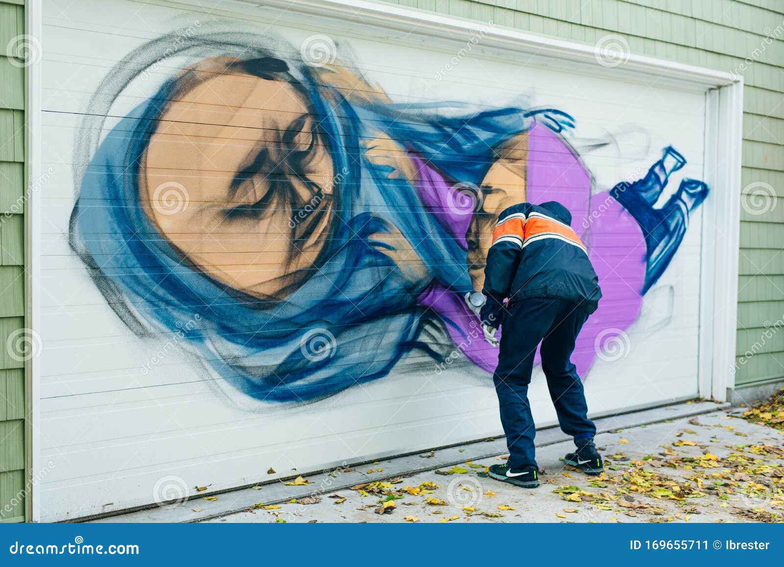 Canada, Toronto December, 2019 Graffiti Artist Spraying the Wall