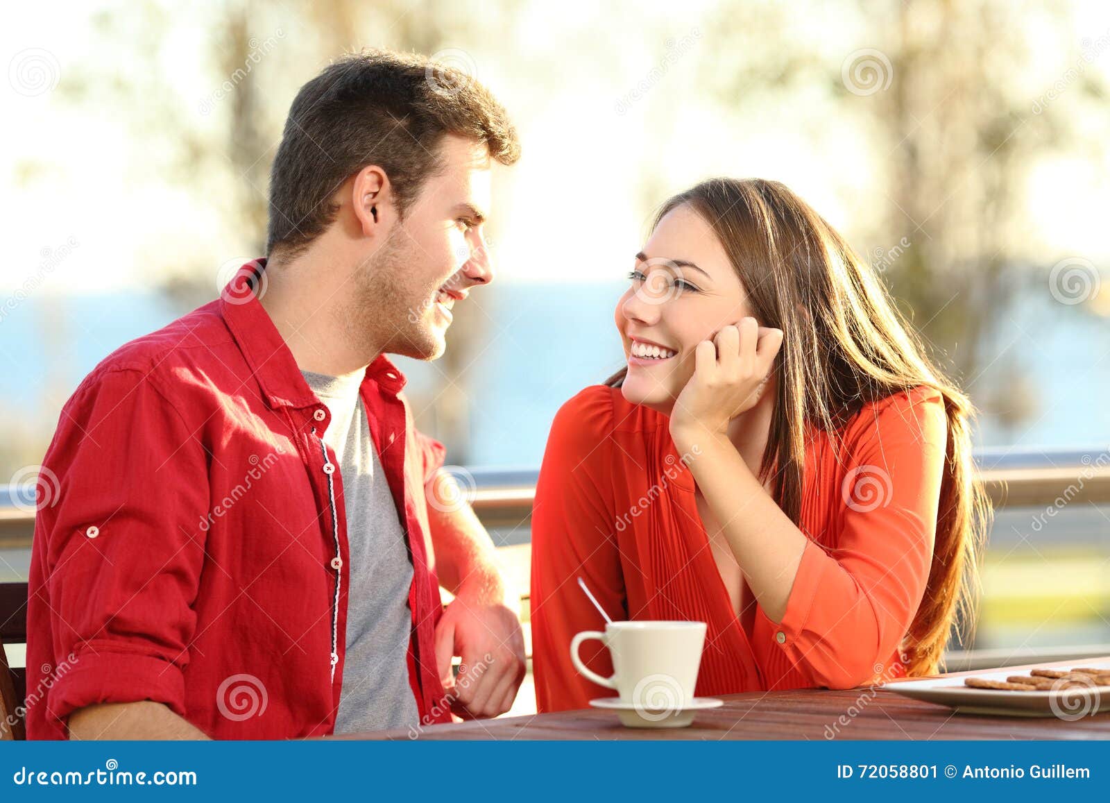 candid couple in love flirting in a terrace