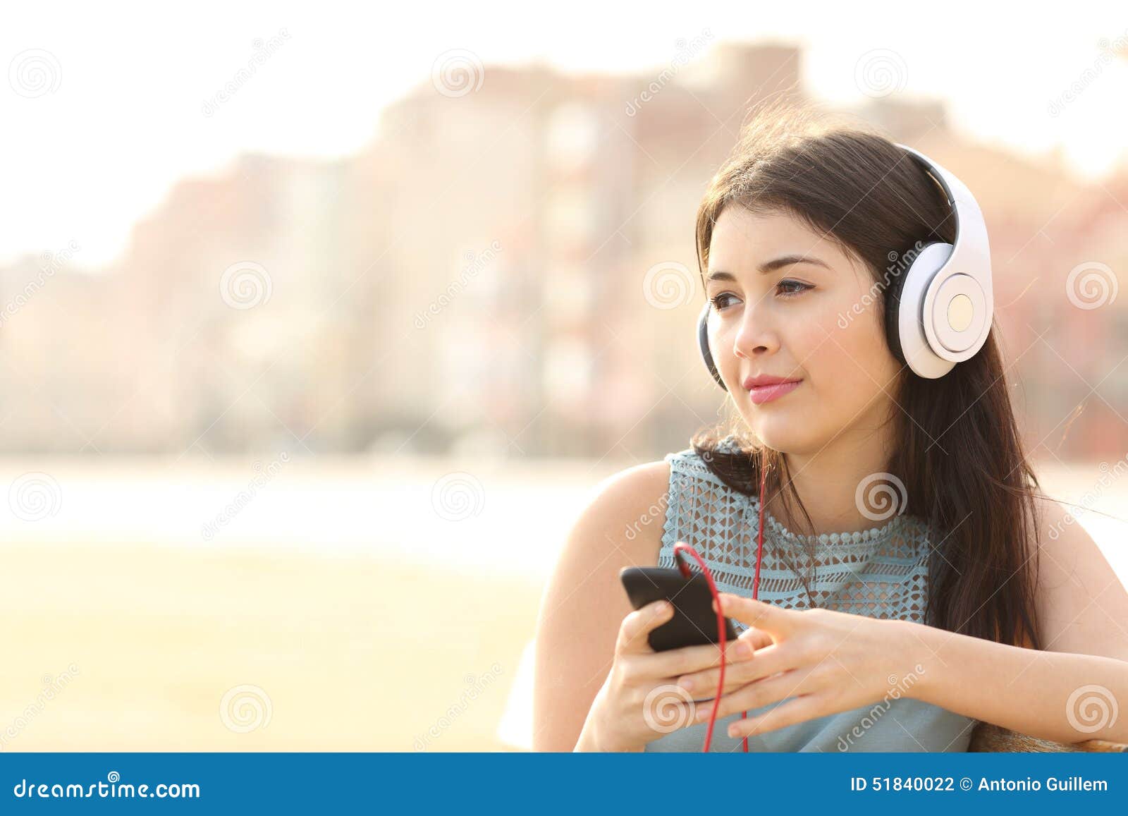 candid girl listening music with a smartphone