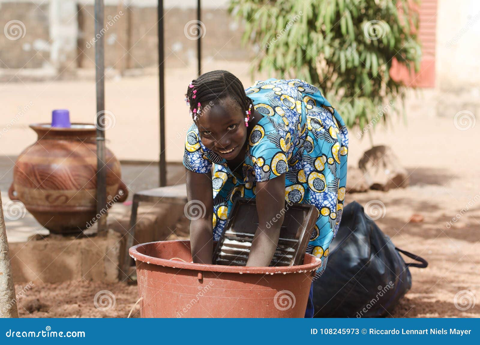 candid shot of african black ethnicity girl child labour