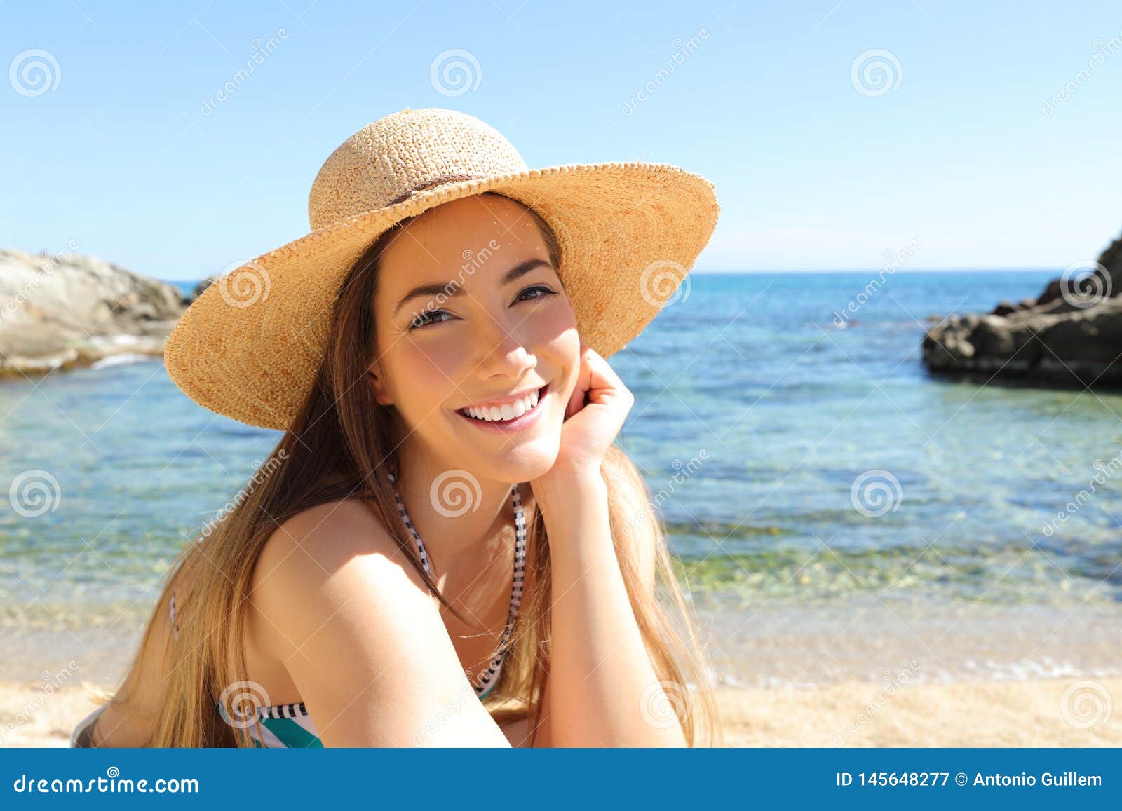 candid tourist on the beach looking at camera