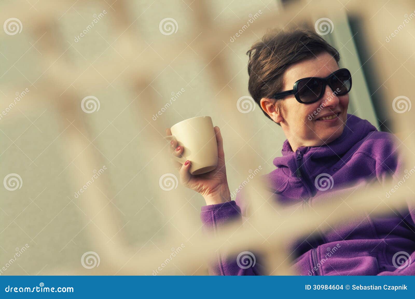 candid woman outdoors with coffee