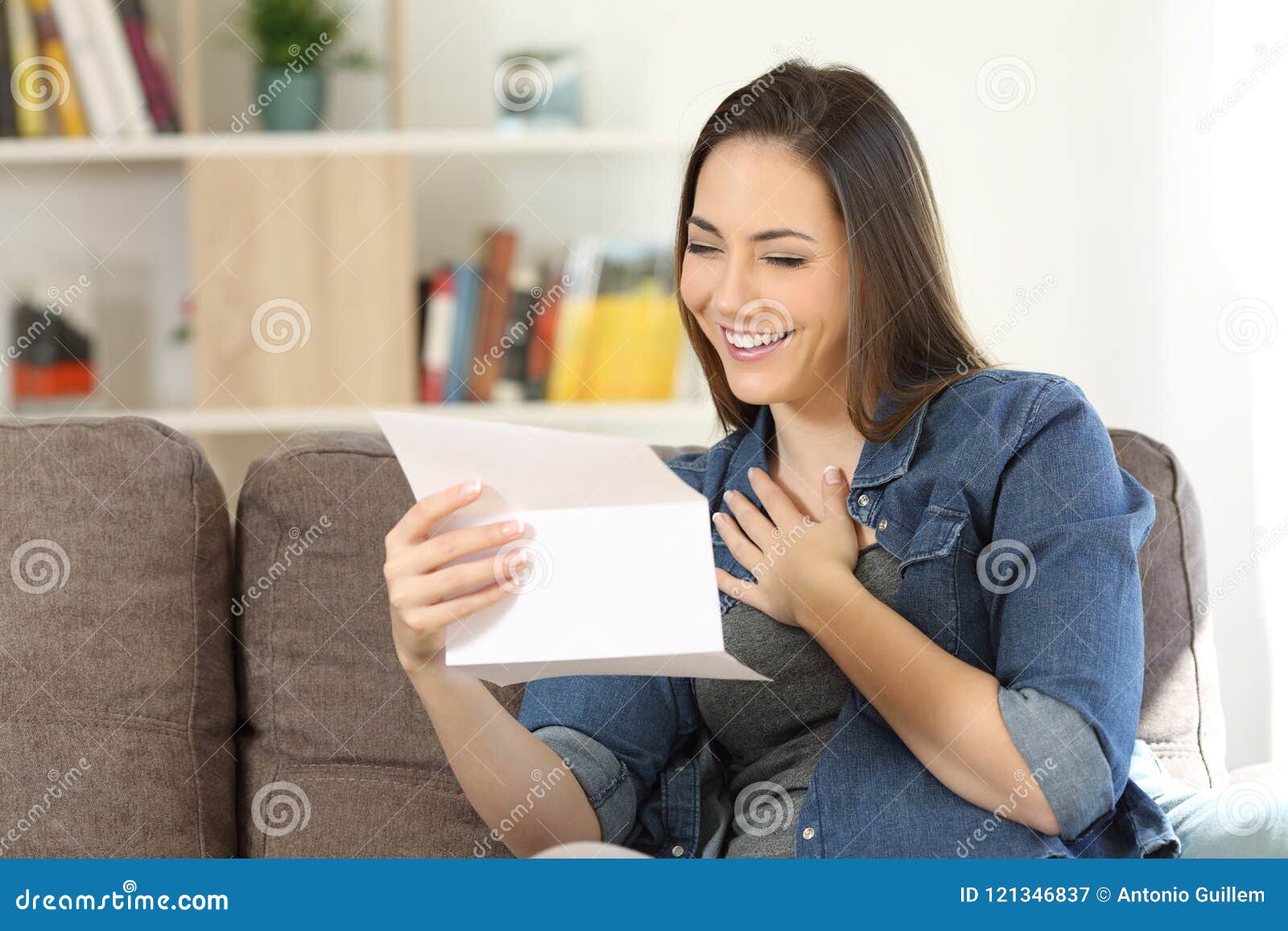 candid woman reading hopeful news in a letter