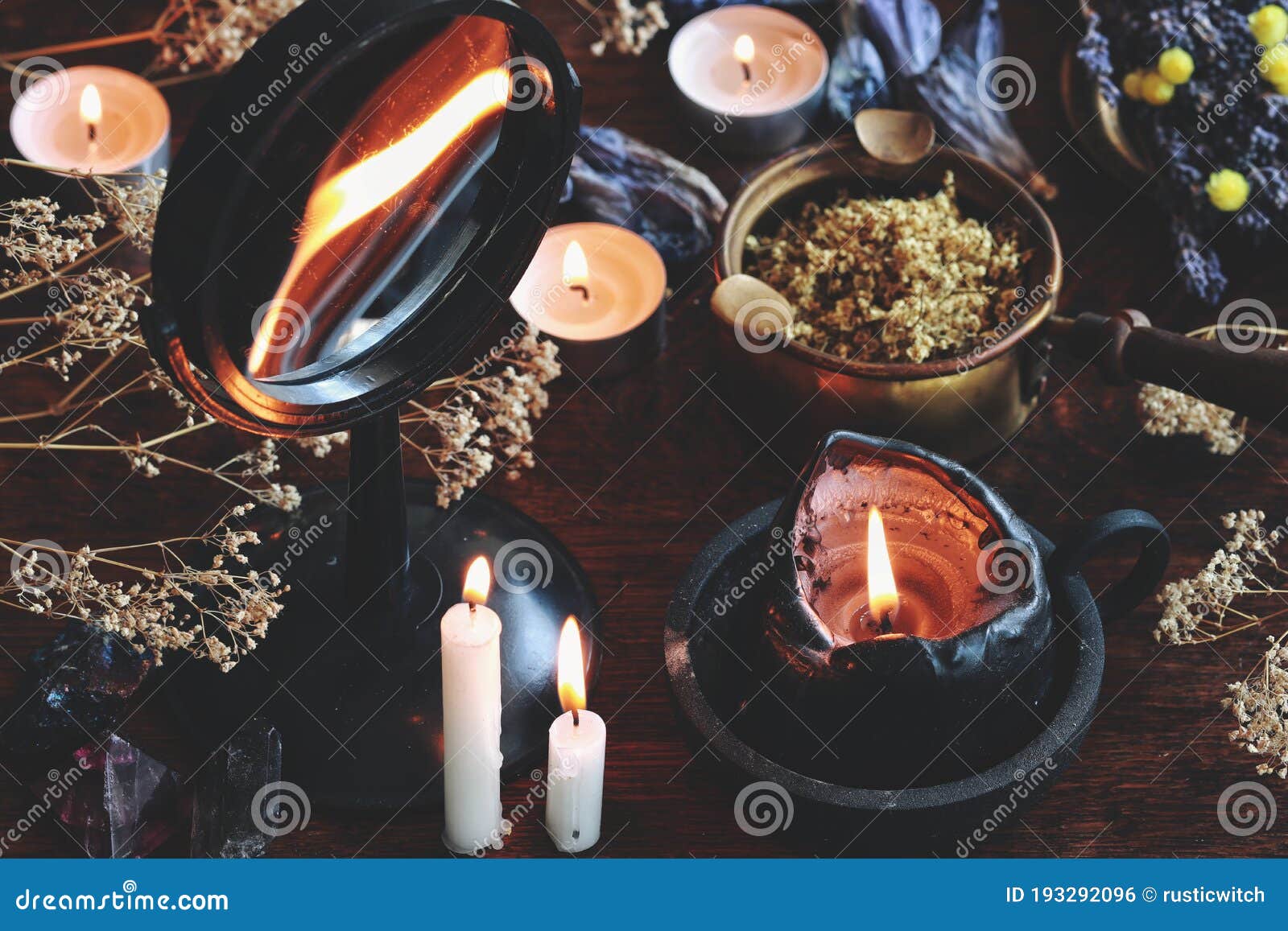candle flame divination in concave mirror on wiccan witch altar