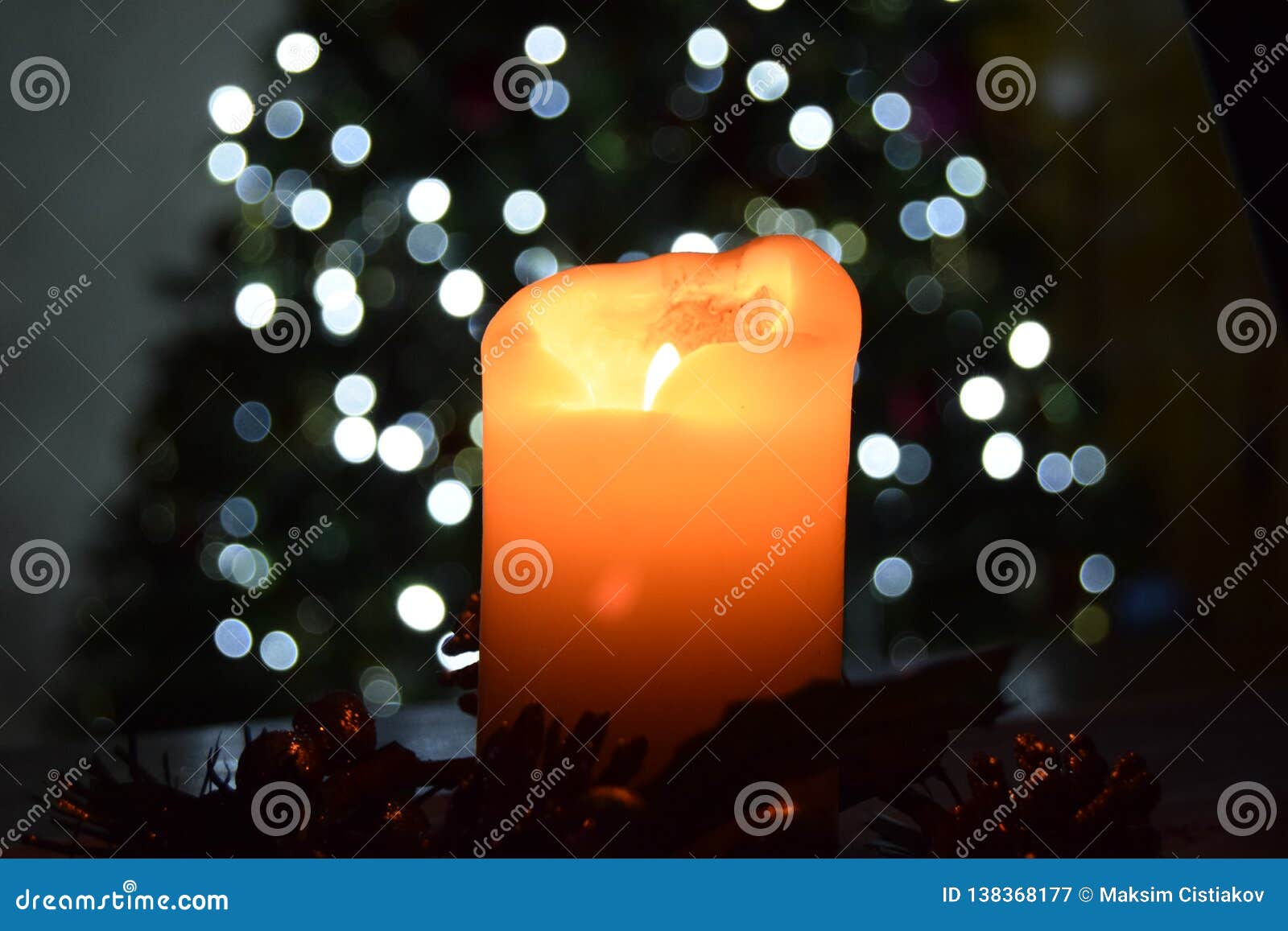 Candle Light in Front of Christmas Tree on Background Stock Image