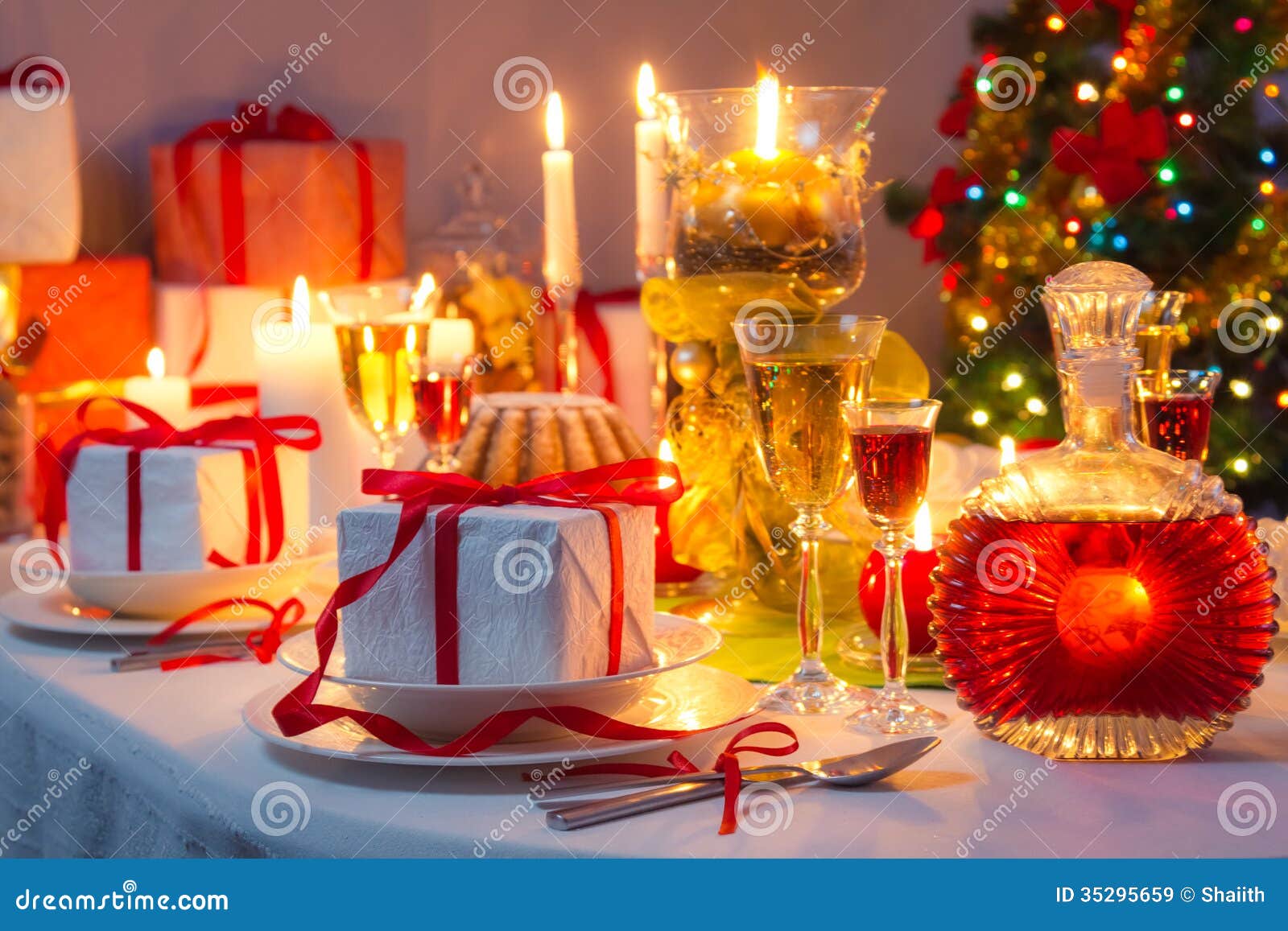 Candlelight and Gifts All Around the Christmas Table Stock Image