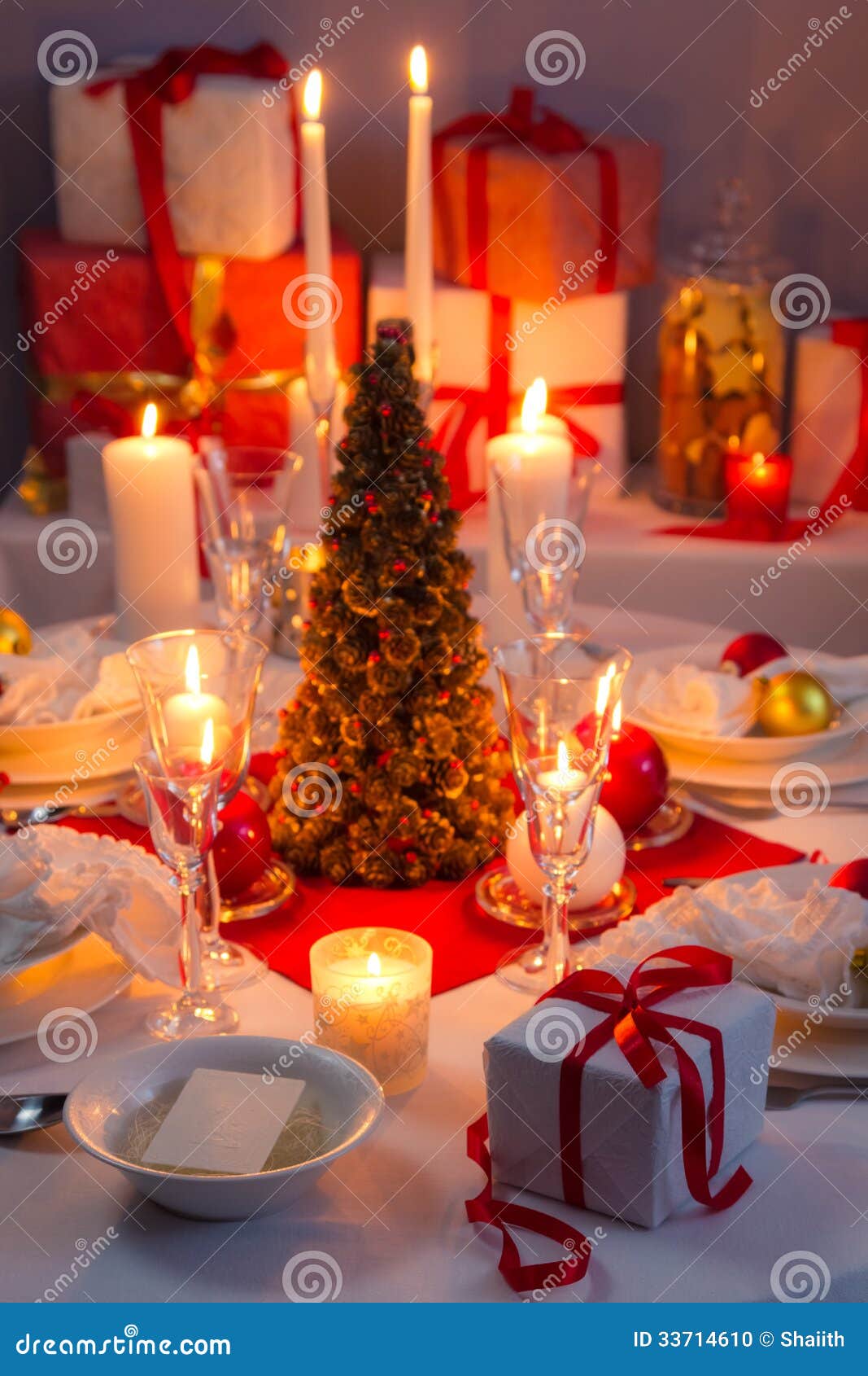 Candlelight, Wafer and Gifts on the Christmas Table Stock Photo Image