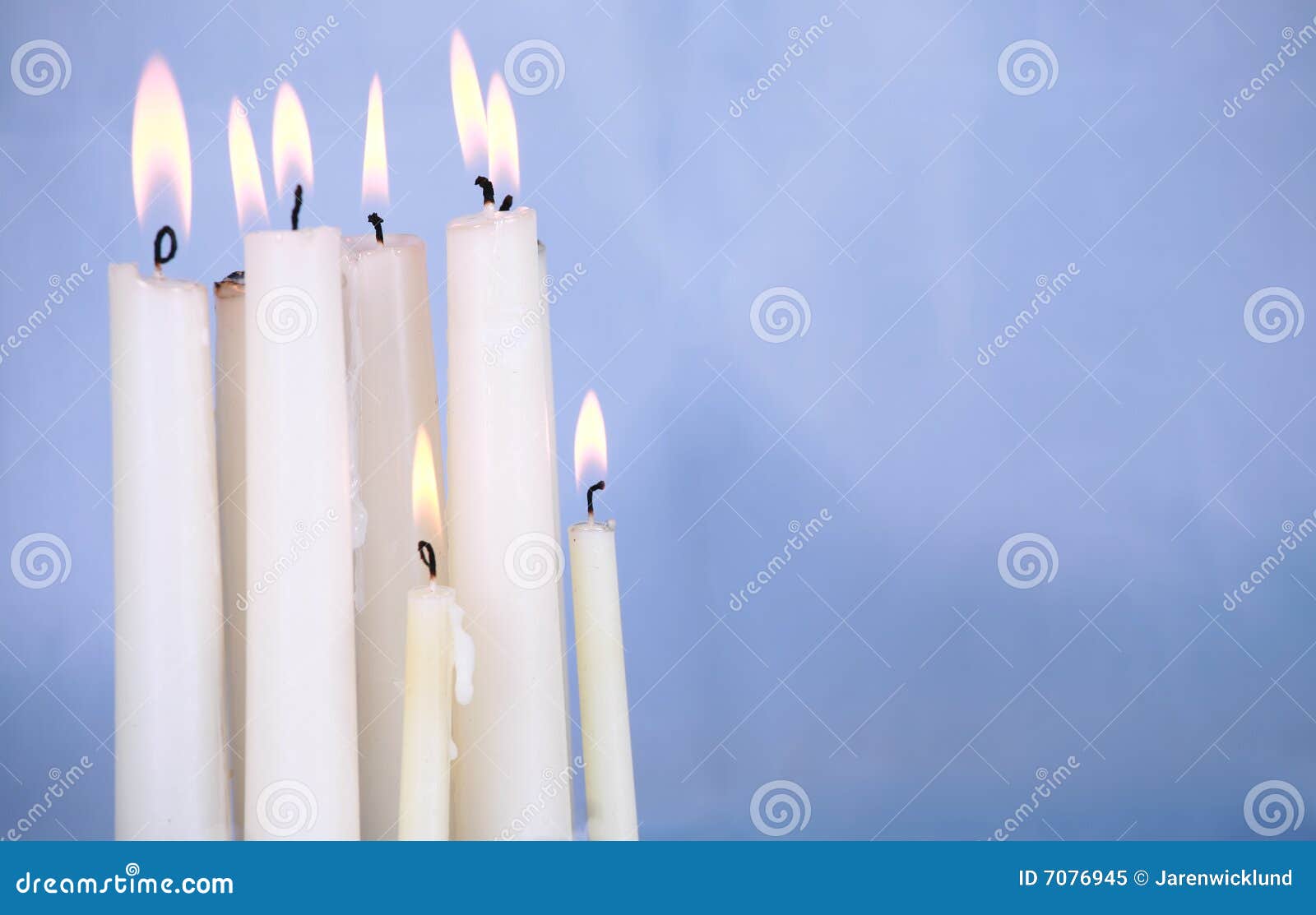Two Candles Burning In The Dark With Double Fire And Bokeh Lights Stock