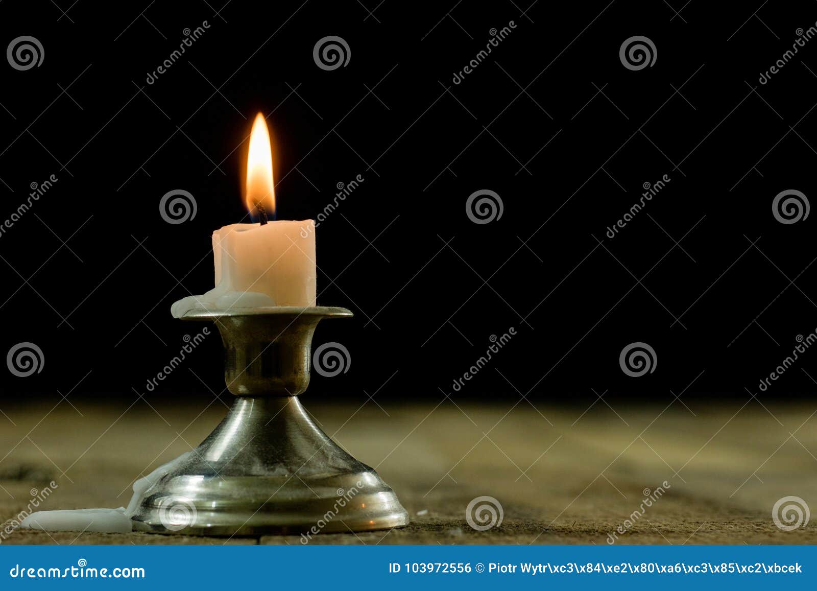 Candles Burning In Candlesticks On A Wooden Table. Silver Candle Stock