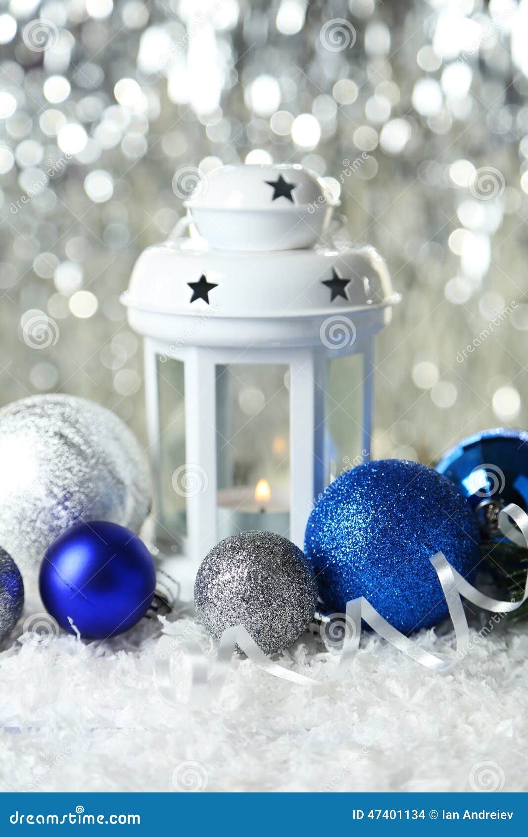 Candlestick with Christmas Ball on Lights Background Stock Photo