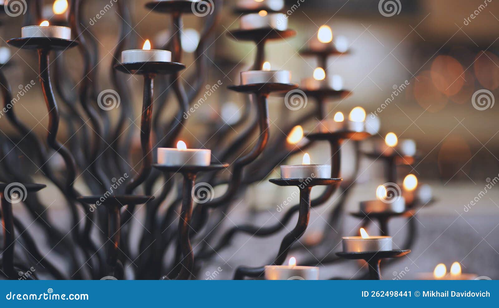 Candlestick Holder with Burning Candles in a Catholic Church. Stock