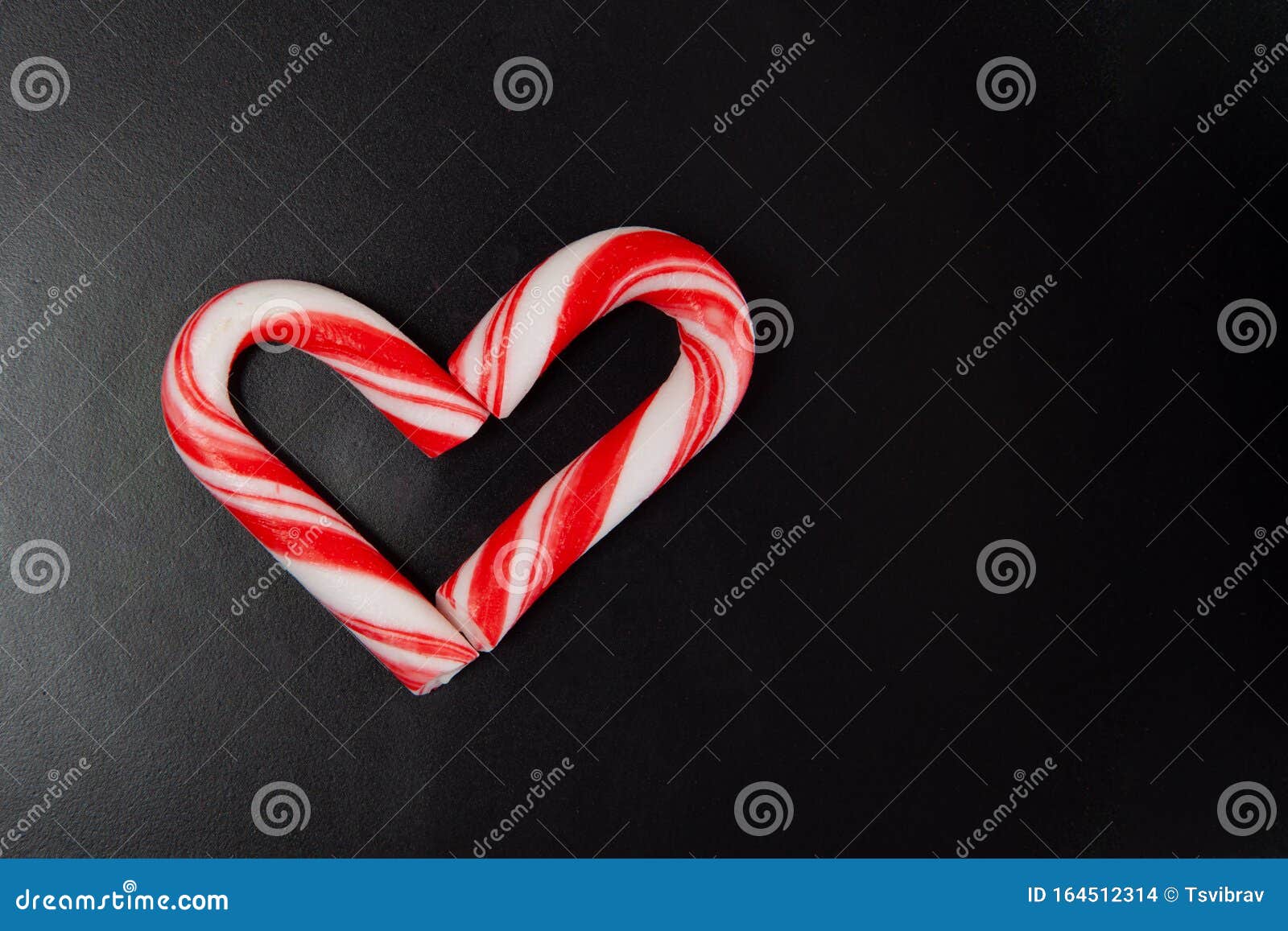 Candy Canes Arranged in Heart Shape on Black Background. Stock Photo ...