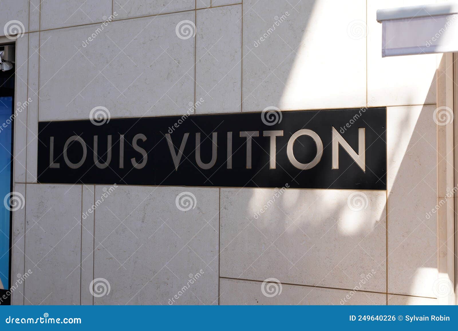 Louis Vuitton Logo Brand and Text Sign Front Wall Facade of Home