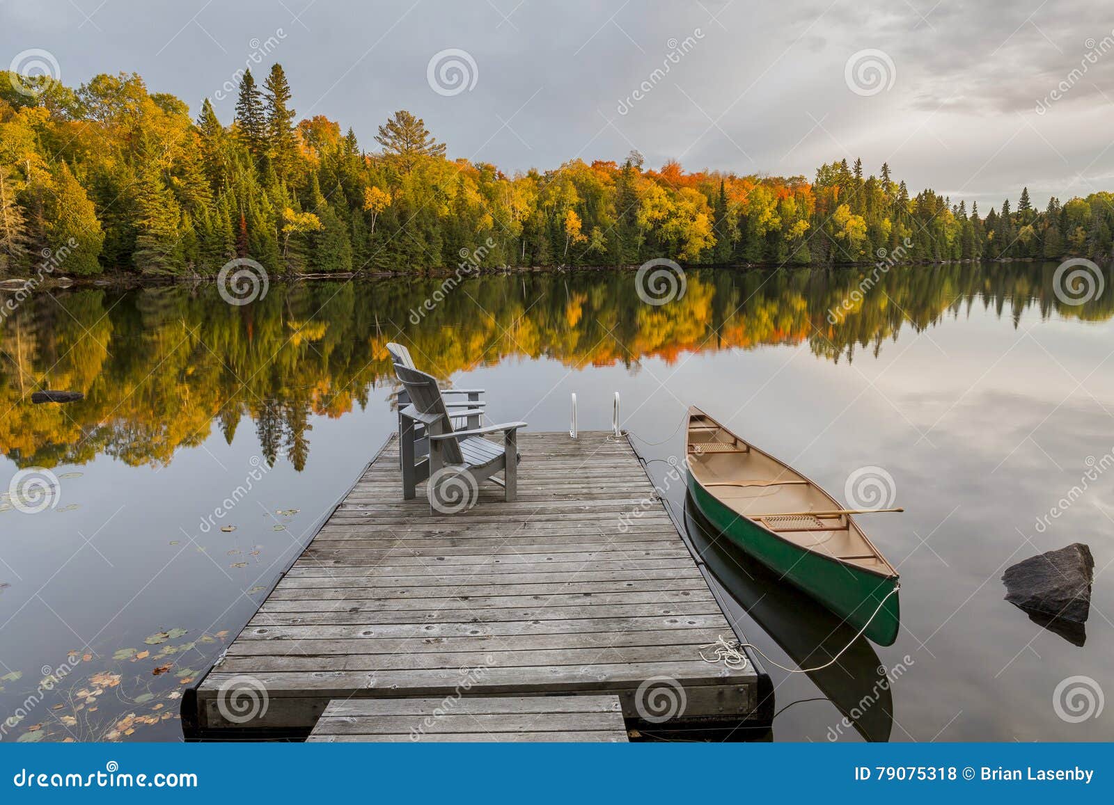 canoe and dock on an autumn lake - ontario, canada