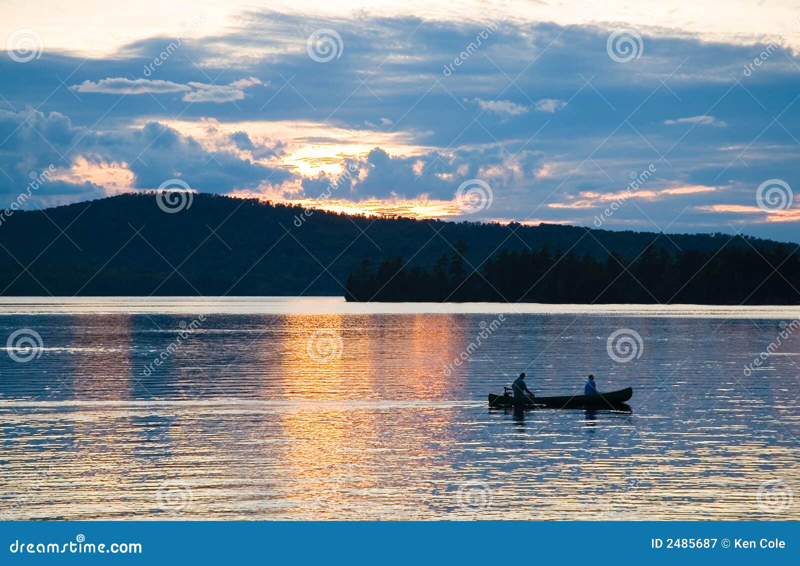 canoe on lake at sunset