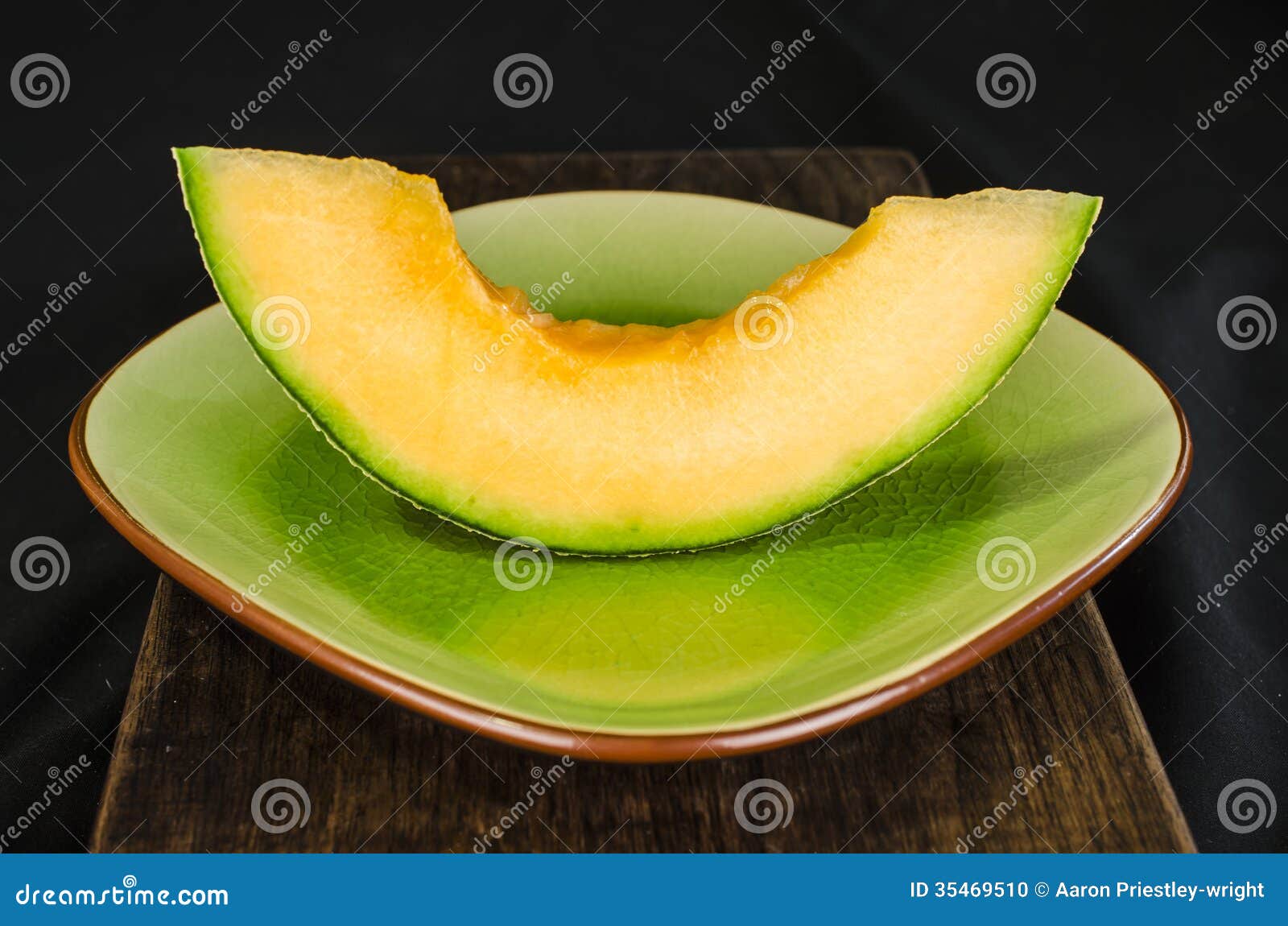 Cantaloup Slice on a plate stock photo. Image of green 35469510