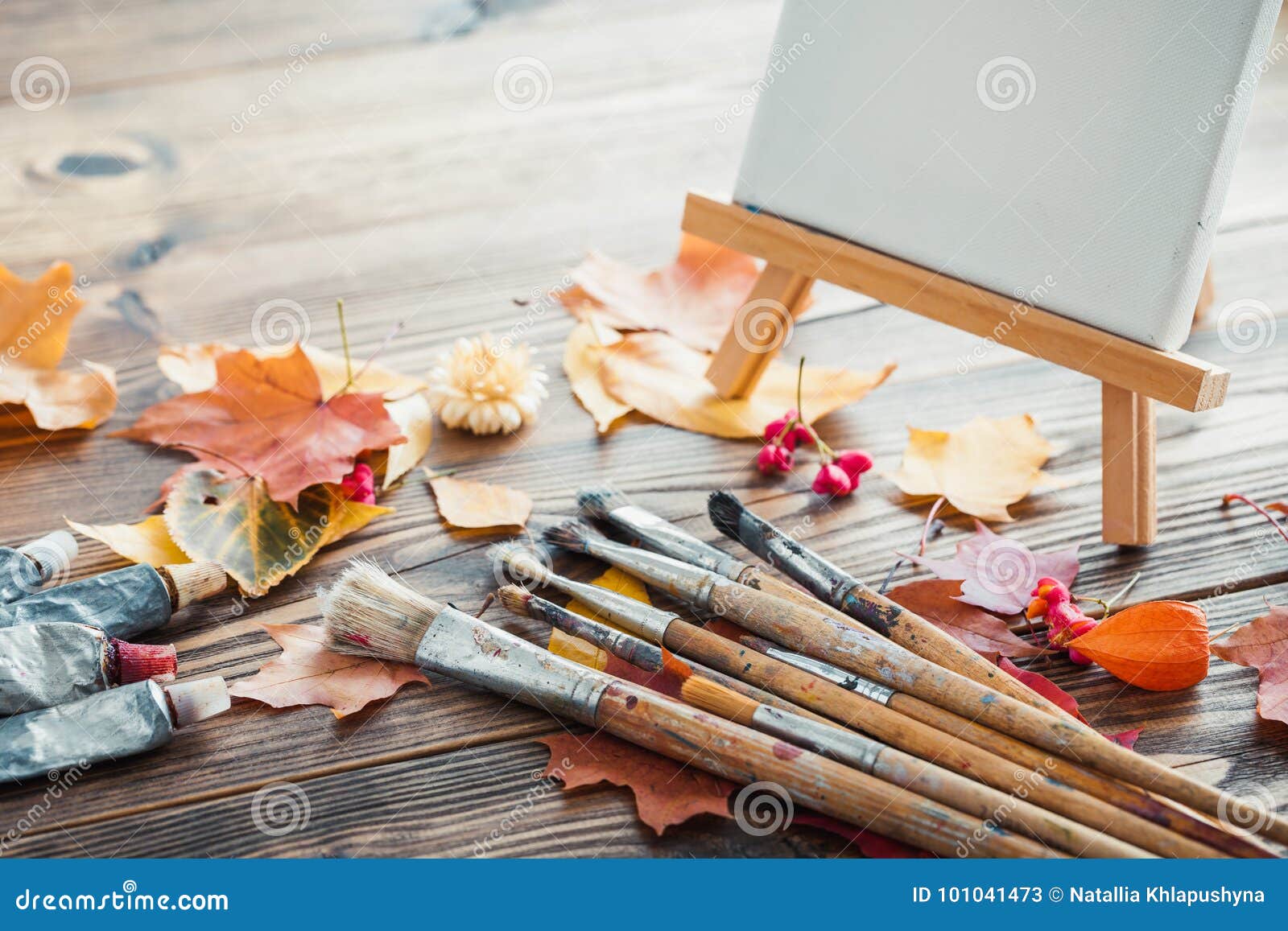 Artist paintbrushes, paint tubes and small easel with canvas closeup. Top  view. Stock Photo by ©ChamilleWhite 184639884