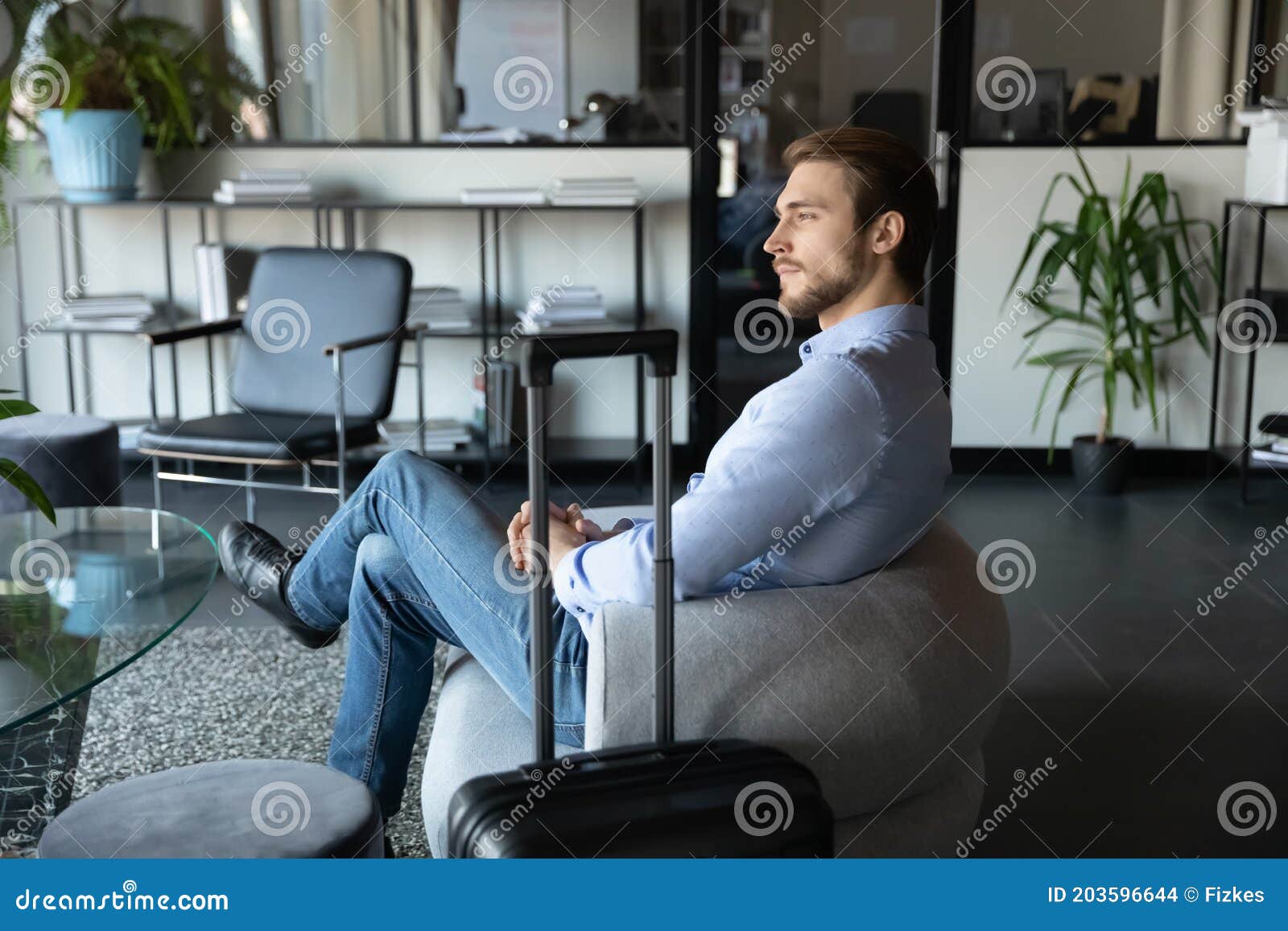 capable millennial male expert travelling on business waiting for meeting