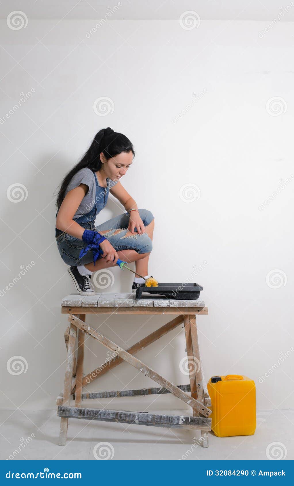 capable woman painting the wall of her house