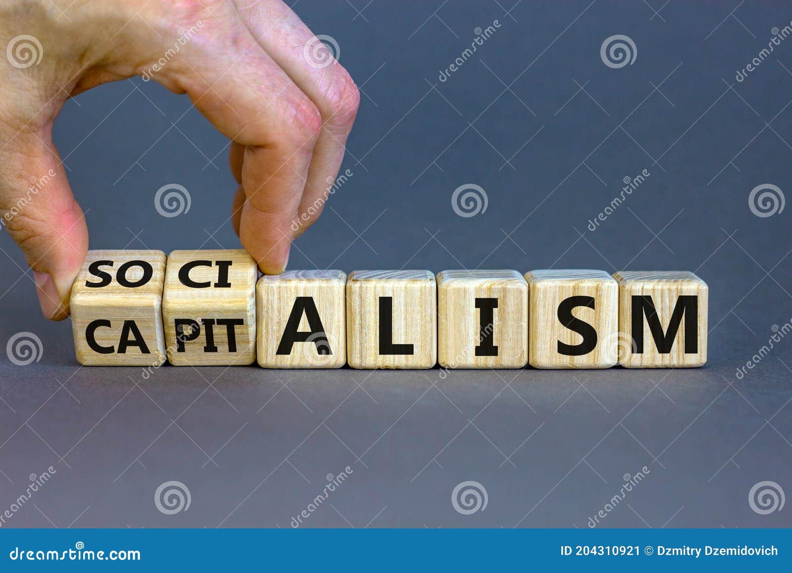 capitalism or socialism. hand turns cubes and changes word `capitalism` to `socialism`. beautiful white background, copy space