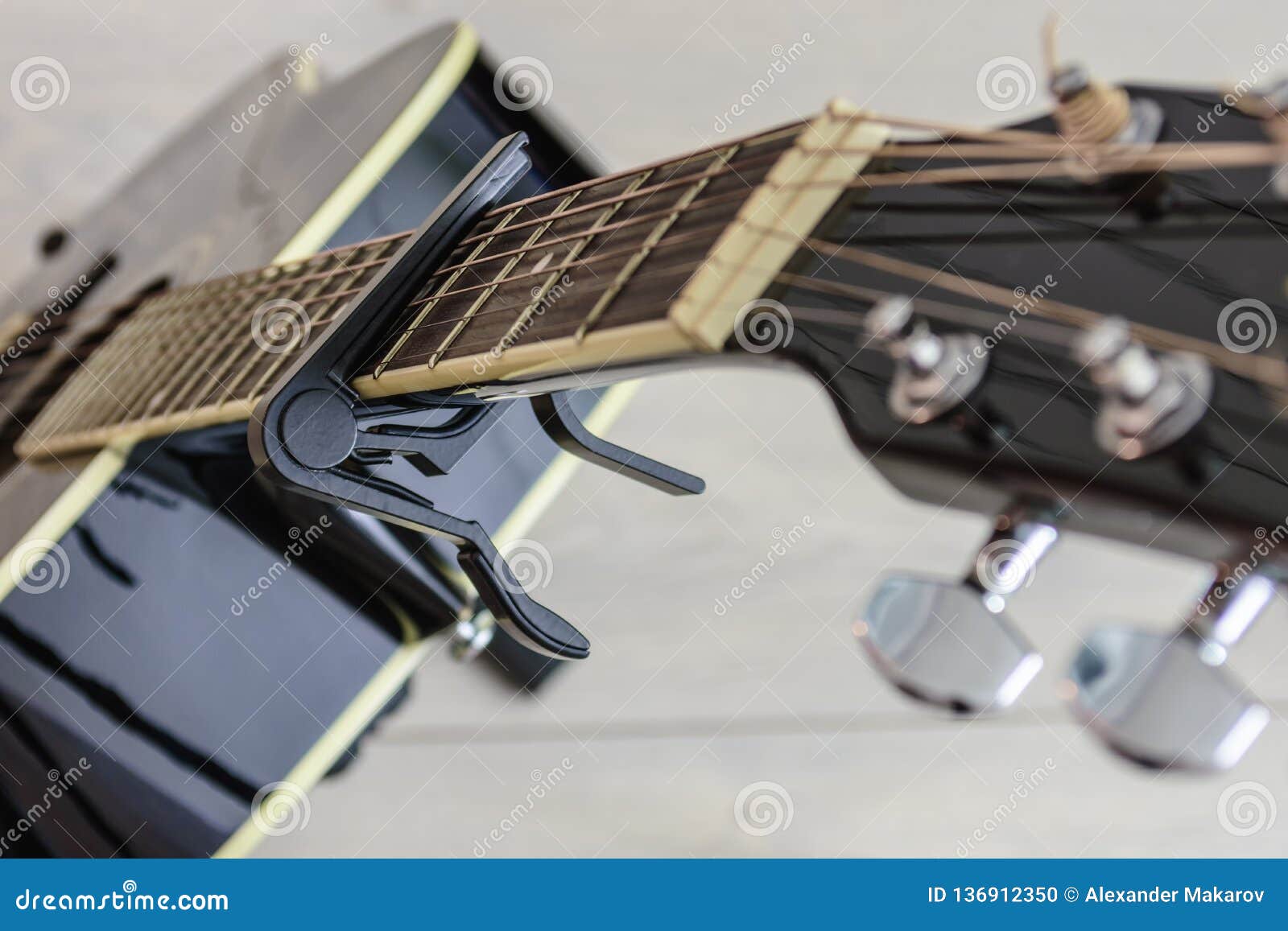Capo Mounted on the Neck of a Guitar Stock Photo Image of background