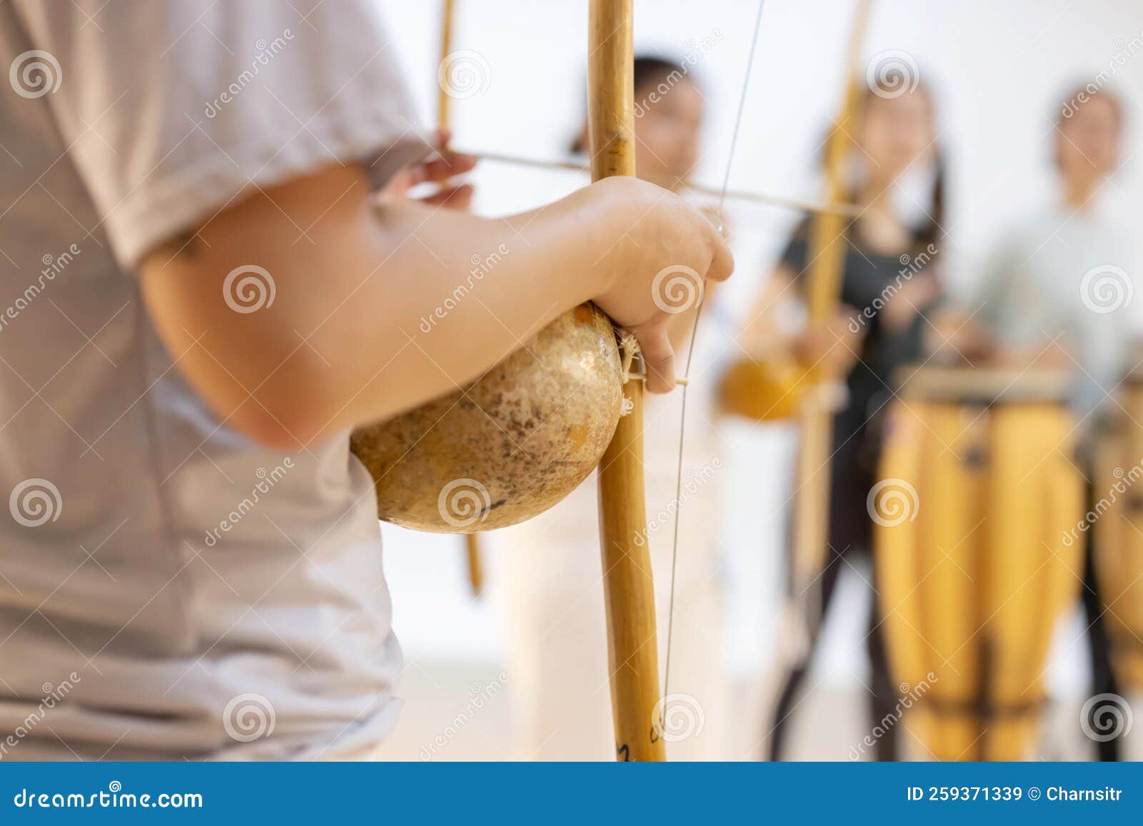 capoeirsta playing berimbau in a capoeira roda