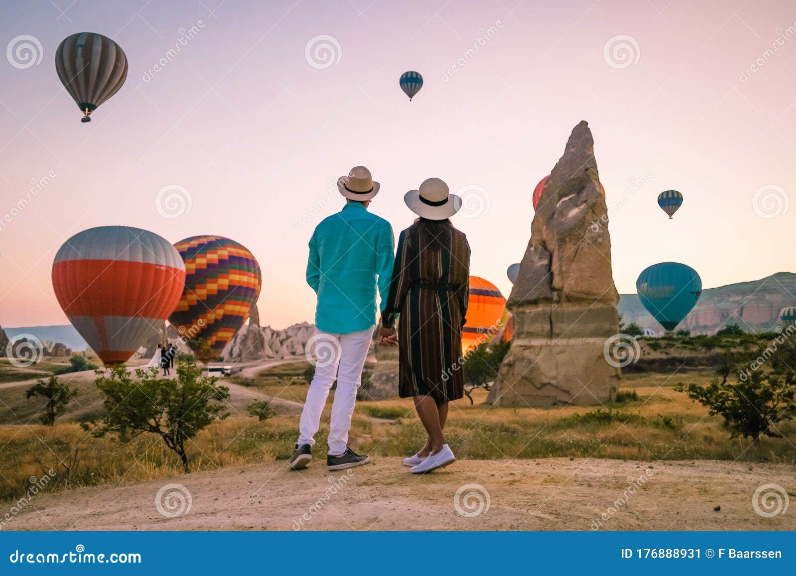 cappadocia turkey during sunrise, couple mid age men and woman on vacation in the hills of goreme capadocia turkey, men