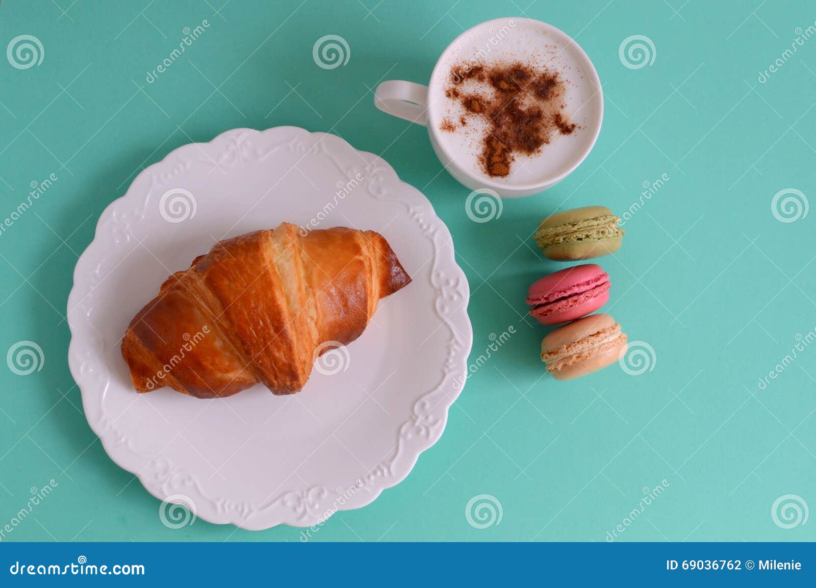 cappuccino with croissant and macarons