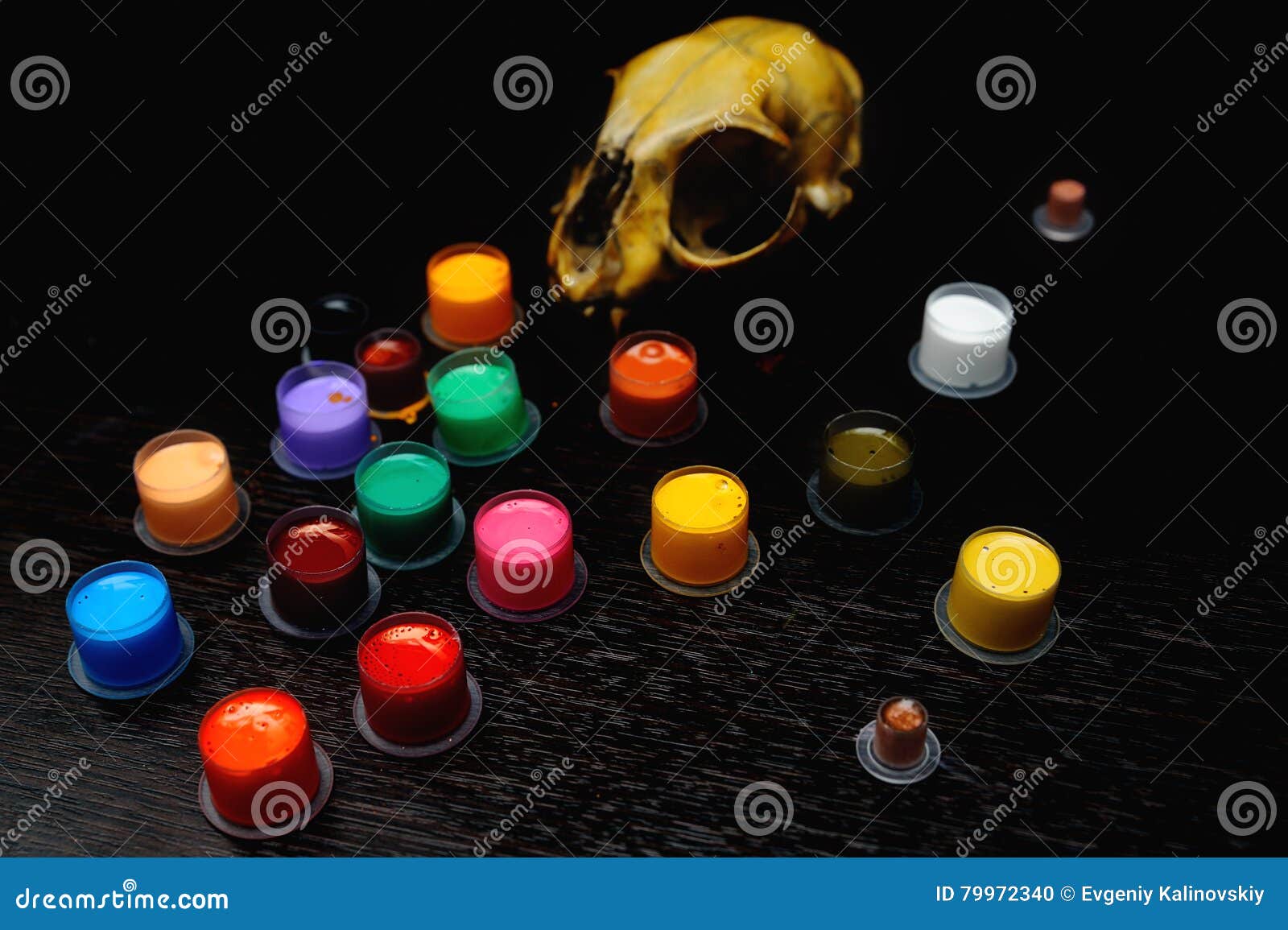 Caps for Tattoo Ink with Colored on the Background of a Skull. Stock