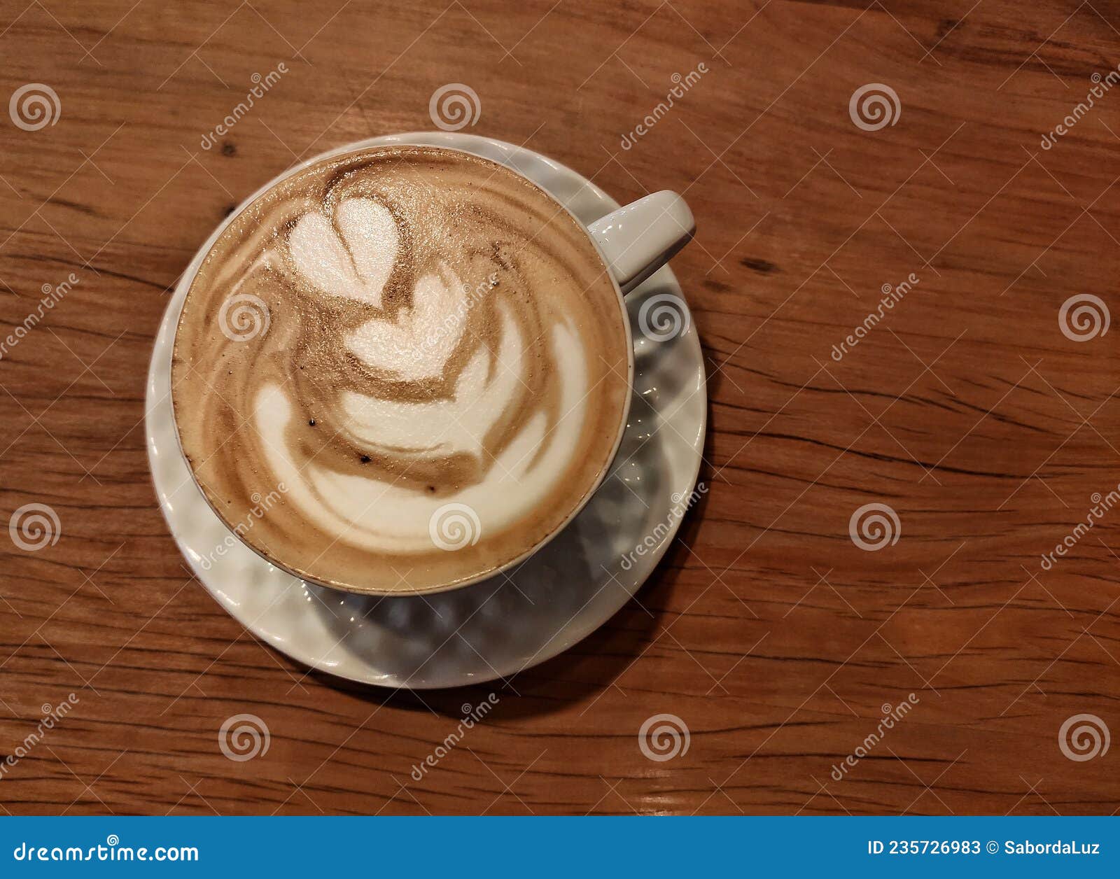 capuccino on a wood table and white cup